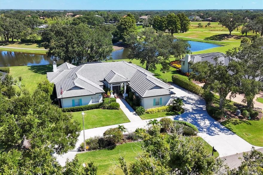 A rare opportunity in Laurel Oak; a stunningly renovated move-in ready custom estate. Set on a peaceful half-acre lot adorned with majestic oaks and swaying palms, this beautiful 4-bedroom, 4-bathroom home offers over 4125 square feet of modern luxury, architectural charm, and breathtaking views. Soaring vaulted ceilings, custom crown molding, accent tile walls, and designer light fixtures and chandeliers add elegance throughout. The interior has been freshly painted and designed to enhance the natural light that pours into every room. You will feel the high-quality craftsmanship the moment you enter this home; it has been thoughtfully updated to the highest standards. The heart of the home is the stunning 2024 kitchen remodel, featuring Café appliances, quartz countertops, a Brizo touch faucet, instant hot water, under-counter filtration, and a spacious cabinet pantry. Lutron-controlled under and over-cabinet lighting creates an inviting ambiance, perfect for both daily living and entertaining. The expansive primary suite is a private retreat with pool views, two walk-in closets, and a spa-like bathroom with a freestanding soaking tub, oversized shower, and dual vanities. The three generously sized guest bedrooms offer unique details and exceptional comfort. The unique floor plan boasts views of the heated pool from almost every room. The large lanai features a panoramic screen that frames the tranquil lake in the backyard, where deer and birds frequently visit, and an outdoor kitchen with a Lynx built-in grill, drink cooler, custom cabinetry, and matching quartz counters. There is a dedicated pool bath accessible directly from the lanai – all creating an ideal addition for effortless entertaining. This smart home includes a Nest thermostat, security system, smart door locks, programmable irrigation, and outdoor lighting, plus a Tesla charger and a 2022 roof for peace of mind. Laurel Oak offers 24/7 guard-gated security, two championship golf courses, tennis and pickleball courts, a junior Olympic swimming pool, vibrant clubhouse, and reciprocal membership with Bird Key Yacht Club. Membership is available but not required. Enjoy the best of Florida living in a truly unique and luxurious home.