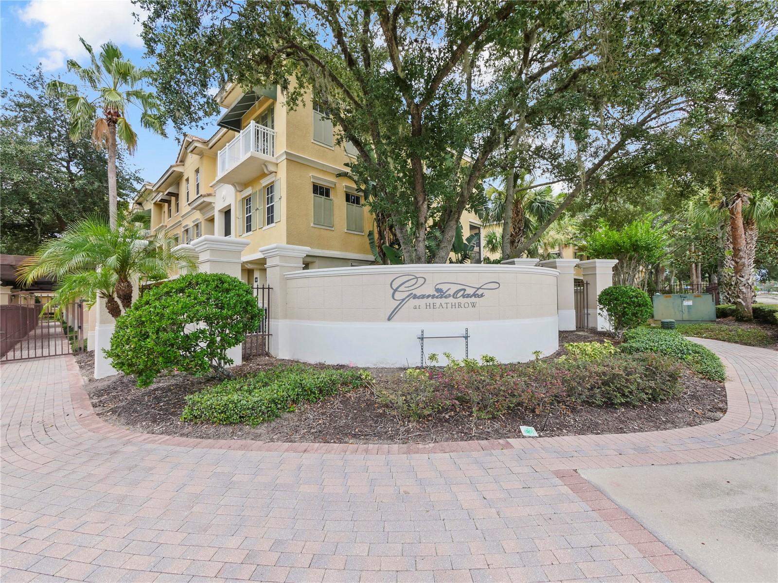 Enter through the gates to your own personal RESORT style living in the beautiful GRANDE OAKS AT HEATHROW and into your exquisite townhome that was formerly the actual "Model Home" for the builder. No detail was missed featuring over $100,000 in Designer Upgrades while offering the Best Corner Unit with a Waterfront View and just steps across this wooden bridge into your Club House, Pool, Fitness Center, and more... Come live like you are on Vacation while located in the Business District of Lake Mary within walking distance to Bike trails, incredible Fine Dining, coffee shop, wine bar, shopping, and more… Welcome into this stunning 3 bedroom, 3.5 Bath, 2 car garage immaculate home in pristine condition. Walking in through your privately fenced beautiful Paver Patio up these luxurious custom wooden floors complete into your Stunning Gourmet Chefs Kitchen featuring Gorgeous Granite Countertops, sleek backsplash, an Oversized Island with additional seating, Stainless-Steel Appliances, Double Oven, Warmer, Cooktop, Wine Refrigerator, custom Wine Glass holder, Water Softener, 42" Cabinets with crown molding, tons of soft close cabinets, and drawers. Offering plenty of Natural Lighting with Brand New Windows, Customs Electric Shades, and breath-taking water views of the Pond and Fountain while cooking and entertaining in your spacious Dining and Living Room with a private ½ bath for guests. This spacious living area offers custom lighting, trey ceilings, crown molding, ceiling fan, and French Doors leading to a Huge Balcony offering additional dining and living space with Sunset Views! Invite your guests to come stay in your Private Porcelain Tiled Bonus room located downstairs on the first floor offering a Private Entry, Private Patio, a Full luxurious Bath with custom tile, granite, and lighting with an oversized storage closet and garage entry. This is a great space to also utilize as a home office, private gym, game room, or a luxury Spa. The third level features a gorgeous Master Suite and Designer Master Bath offering a huge walk-in California Closet perfect for organizing, a Third private Balcony to enjoy your morning coffee, a seamless glass shower, custom tile, granite, lighting, and additional linen closet space. This floor also offers 2 generously sized bedrooms, a custom designed full bathroom with decorative tile, granite, and lighting, GE frontloading Washer and Dryer on pedestals, and upgraded cabinets above. Additional upgrades include Window Treatments, Wood and Tile Flooring, Crown Molding, Water Softener throughout, Appliances, Countertops, Smart Features to the door locks and thermostat, Extra Lighting and custom Fixtures, Ceiling fans, automatic shades on the second floor with remote, fire and CO sensors, Central vac, Wireless SimpliSafe system throughout including water sensors, Ring Doorbell, Smart charge point EV charger, Epoxy garage flooring and Overhead Storage Rack, additional closet space through the floors for storage, and is offering the Best location at the end of the street to avoid traffic flow. This is Truly Upscale Carefree Living at its Finest! “All” the furniture may convey for an additional $5,000.00. Conveniently located near I-4, 429, and 417 with easy access to the Florida Beaches, Downtown Orlando, Attractions, the Sanford & Orlando International Airport.
