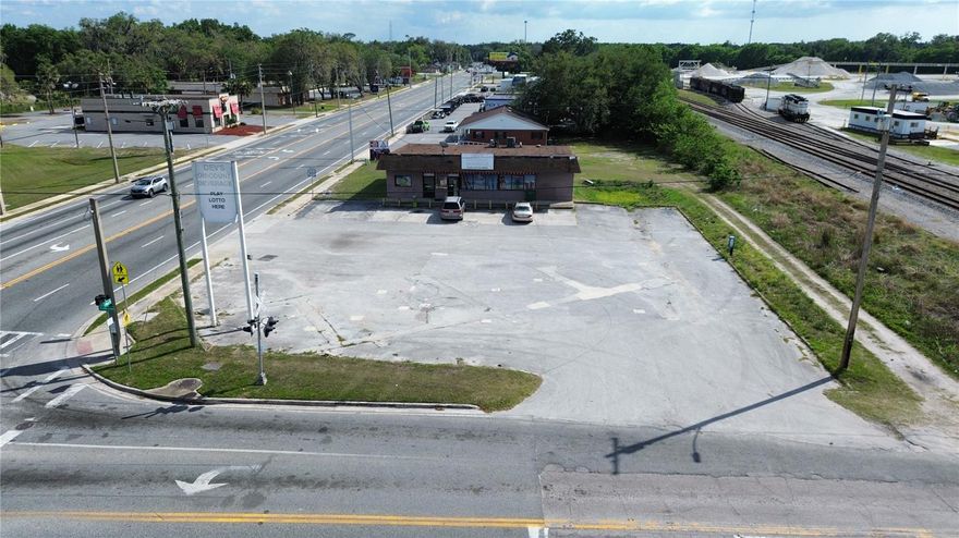 Premier Commercial Opportunity in the Heart of Wildwood
Capitalize on exceptional visibility and growth potential with this prime half-acre commercial offering, strategically positioned along highly traveled US Highway 301. Showcasing approximately 295 feet of road frontage and benefiting from an impressive average daily traffic count of 24,500 vehicles, this prominent corner parcel delivers outstanding exposure within one of Wildwood’s most dynamic commercial corridors.

The property is improved with a substantial 3,111 square foot commercial building—one of the largest available spaces in the downtown area—providing immediate functionality and flexibility for a wide range of business uses. Notably, this site was originally designed for a gas station and convenience store, making it an ideal candidate for reinstating that highly profitable use or reimagining it for another high-traffic retail concept.

Beyond the existing structure, the expansive site offers significant room for expansion and future development. Whether you choose to introduce additional office or retail buildings, or further enhance the primary use, the property presents a rare opportunity to scale and customize to meet your business objectives.

With its strategic positioning, commanding visibility, and exceptional development potential, this offering represents a compelling investment in one of Central Florida’s rapidly growing markets. Opportunities of this caliber are increasingly scarce—secure your foothold in Wildwood’s thriving commercial landscape today.

Whether you are a local commercial property owner, looking to expand your portfolio, or a national brand looking to put roots in a high traffic location, don’t miss the exceptional opportunity. Schedule your showing today!