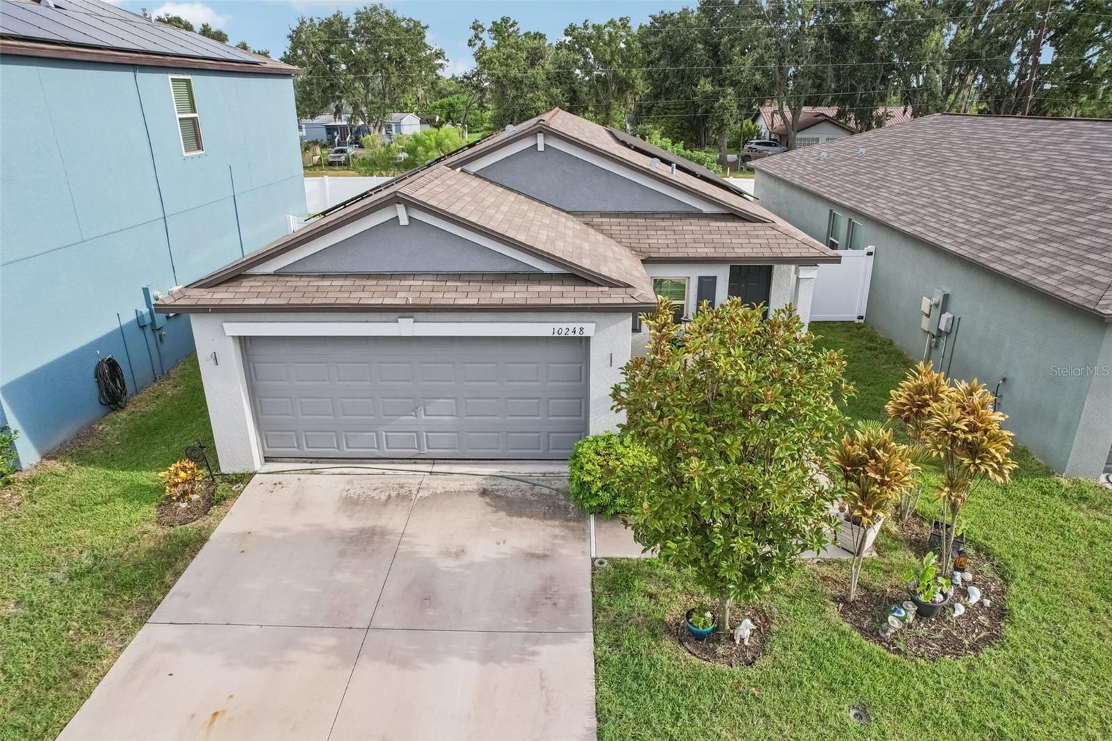 Welcome to this beautifully maintained 3-bedroom, 2-bath home with a 2-car garage located in the desirable Ayersworth Glen community of Wimauma! Lush landscaping and great curb appeal invite you into an open-concept floorplan featuring high ceilings and tile flooring throughout the main living areas. The kitchen, dining, and living spaces flow seamlessly, perfect for both everyday living and entertaining. The spacious primary suite includes a private en suite bathroom, while two additional generously sized bedrooms share a full bath. A separate laundry room adds convenience, and the fully fenced backyard offers privacy and space for outdoor enjoyment. Enjoy resort-style living at Ayersworth Glen, featuring a sparkling pool, modern clubhouse, fully equipped fitness center, basketball court, and more. Ideally situated near Hwy 301 and I-75, you'll be just minutes from shopping, dining, and all your daily needs. Don't miss this move-in ready gem in a vibrant, amenity-rich neighborhood!