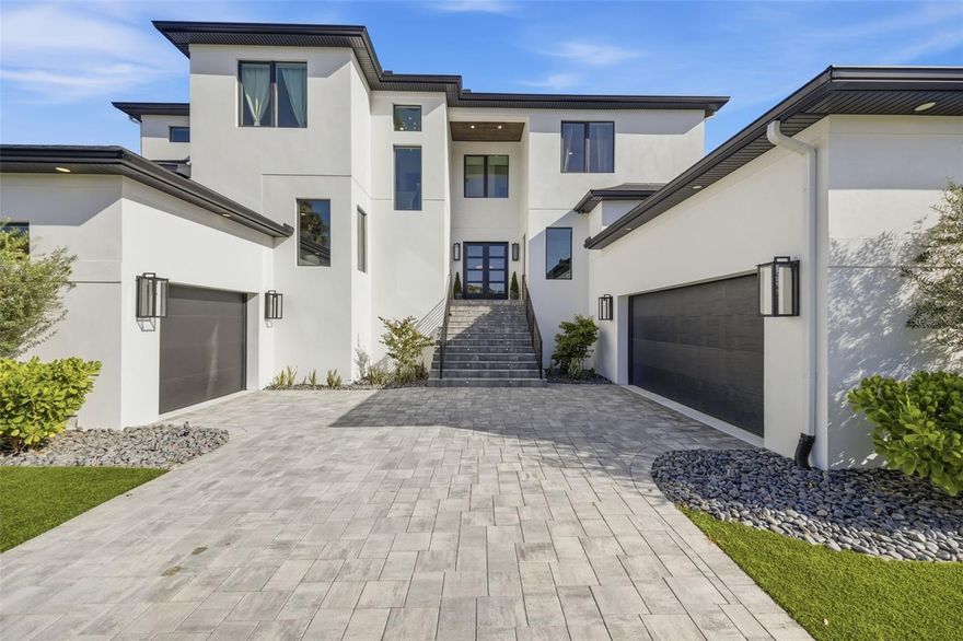 Under contract-accepting backup offers. Welcome to Sunset Park's ultimate statement home where you experience 5,288 square feet of refined luxury in the heart of South Tampa. This one-of-a-kind custom home is only two years old, giving you confidence in the home as it has been lived in and loved on with meticulous care. The gorgeous home sits on an expansive 88’ x 140’ double lot surrounded by other newly constructed residences and is truly a showstopper. Designed with both style and comfort in mind, this home defines luxury living and offers abundant space for entertaining and everyday enjoyment. This exceptional residence showcases an expansive open-concept kitchen and great room accented by elegant coffered ceilings and featuring all premium Viking appliances. Custom all-wood cabinetry with soft-close drawers and hand-finished doors is complemented by premium quartz countertops throughout. Additional highlights include a spacious walk-in pantry with custom wood shelving and sink prep area, a glass-enclosed, climate-controlled wine room—perfect for show-stopping conversations. Luxury details abound, including wide-plank, hand-scraped natural wood flooring, 8’ solid-core doors, impact-rated windows and doors, decorative millwork with wainscoting, and a private elevator. The home is filled with the high-end amenities today’s discerning buyer seeks, including a decadent bar for the entertainer and dual laundry rooms on each floor for maximum convenience—this home truly has it all. The private owner’s retreat, which is located downstairs, offers oversized custom walk-in closets and a spa-inspired bathroom complete with a walk-through shower, freestanding soaking tub, and state-of-the-art Moen fixtures, including the Moen U digital shower system with LCD control. Designed for both entertaining and everyday living, the home also features a 400+ square foot media/game/flex room. Four-panel, 12’ pocketing sliding doors seamlessly connect the interior to a true Florida outdoor living experience, showcasing an oversized lanai with stone decking, a beautifully finished wood ceiling, a full outdoor kitchen with a large seating bar area, and a custom pool with spa and cascading waterfall. Additional features include a whole-home generator, alarm system, smooth drywall finish, 3 car garage, and Smart Home readiness with numerous included features. Contact me today for your private tour of 4815 Sunset Blvd.