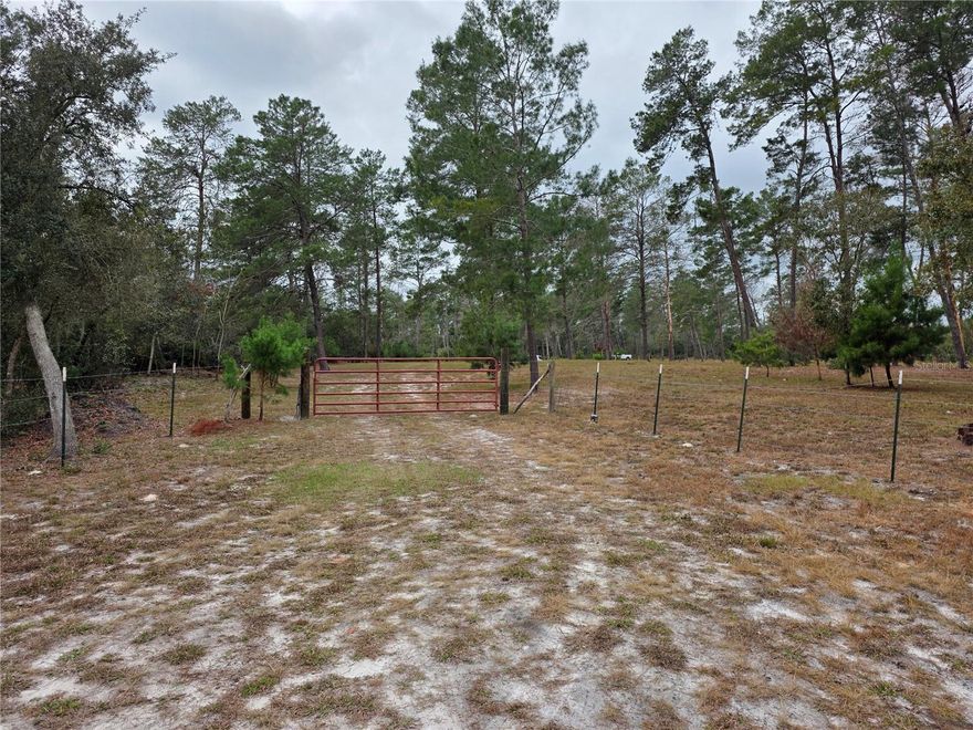 This is a fully fenced 7.5 acre lot that has been mostly cleared of trees and brush. The property has a private gate and a small pond. at least 3/4 of the lot is dryland and buildable. The property has direct access to the main dirt road which power lines run parallel to. One area of the lot was cleared to accomodate a future your home.