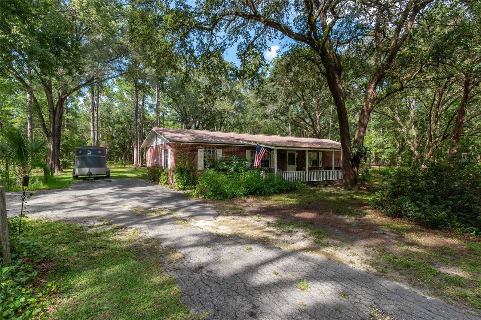 Discover 7.83 acres of peaceful countryside living—perfect for outdoor enthusiasts and animal lovers alike. This A1-zoned property is fully fenced and features four pastures used for horse grazing, a barn, and a 4-stall run-in shelter ideal for feeding and caring for livestock. A large pond and a seasonal creek invite deer, turkeys, and other native wildlife which offers a front-row seat to Florida’s natural beauty. The 3-bedroom, 2-bath concrete block home provides a solid foundation—simple, functional, and ready for your personal touch. Located just 1 mile off Hwy 315, only 10 minutes to major grocery stores and daily conveniences, and just 2.5 miles from scenic Gores Landing for river access and recreation, this property offers the best of both worlds: room to roam with town still close by. Whether you're dreaming of a mini farm, quiet retreat, or a place to build your vision, this land is ready to welcome you home!
Some photos have been virtually staged for illustration purposes only.