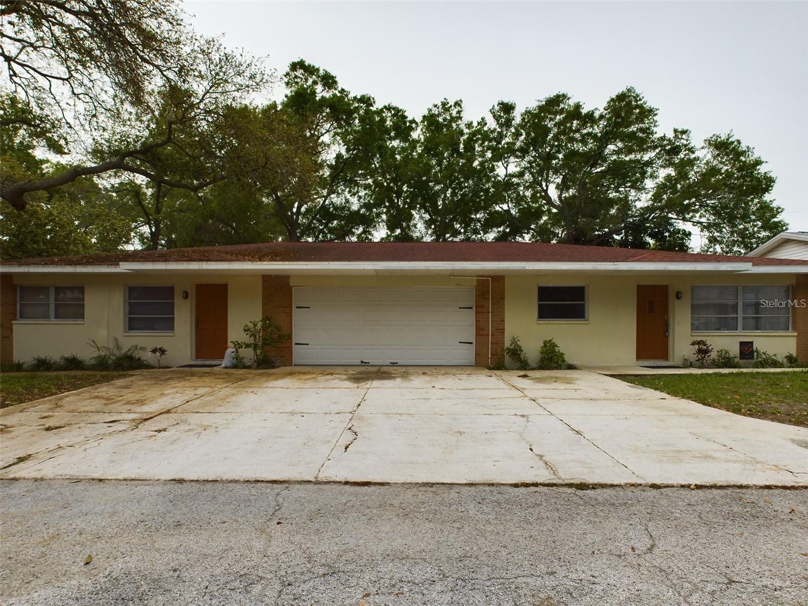 Great Seminole location one half of duplex three bedroom two bath. Two car garage has hookups for washer and dryer and second full bath is in garage. Split floor plan and large family room with fireplace.