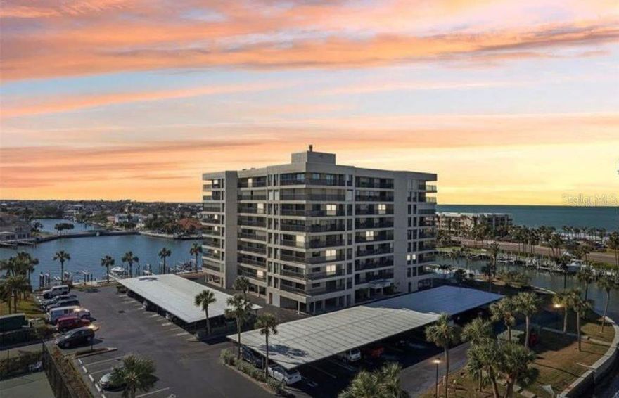 *Milestone Report Completed* *Building DID NOT flood during the past hurricanes.* Welcome to this spectacular Harborage Sand Key condo with Million Dollar Views, nestled in the heart of Sand Key just moments from Clearwater Beach. Embrace the breathtaking vistas of the Intracoastal Waterway and the Gulf of Mexico from your expansive 47-foot wrap-around balcony – a serene backdrop for both sunrise and sunset views. This spacious 2-bedroom, 2-bathroom residence boasts an open floor plan spanning 1,530 square feet, ideal for coastal living. Recently upgraded with new slider doors, hurricane-impact windows, a new AC unit, and a new toilet in the guest bathroom, this home offers both comfort and security. Enjoy the convenience of a large laundry room with extra storage. Set within a maintenance-free, 24-hour gated community, residents have access to amenities such as boat slips (for purchase or lease), a heated pool, grilling areas with picnic tables, and a tennis, pickleball, and shuffleboard court. Recent community enhancements include a new roof (January 2021), updated sports courts (2020), brand-new storage unit doors, repainted the whole building within the last six months, and renovated pool facilities. Unit comes with one covered parking spot (#49) and one storage unit (#40). Seize the opportunity to live the quintessential Florida lifestyle – schedule your private viewing today! Priced to sell with room for upgrades!