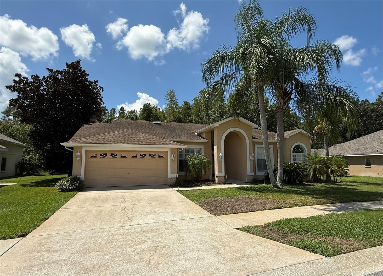 Welcome to this beautiful 4-bedroom, 2-bathroom home with a 2-car garage, located in the desirable Trinity Oaks neighborhood. Sitting on a quarter-acre conservation lot, this property offers both space and privacy. Inside, you’ll find a formal living room, a dining area, and a cozy family room featuring a wood-burning fireplace—perfect for entertaining and relaxing. The primary suite offers a true retreat with its private en-suite bath. The screened-in lanai provides the ideal space for year-round enjoyment, while the expansive backyard offers a peaceful conservation view—perfect for outdoor activities, gatherings, or simply soaking up the Florida sunshine.