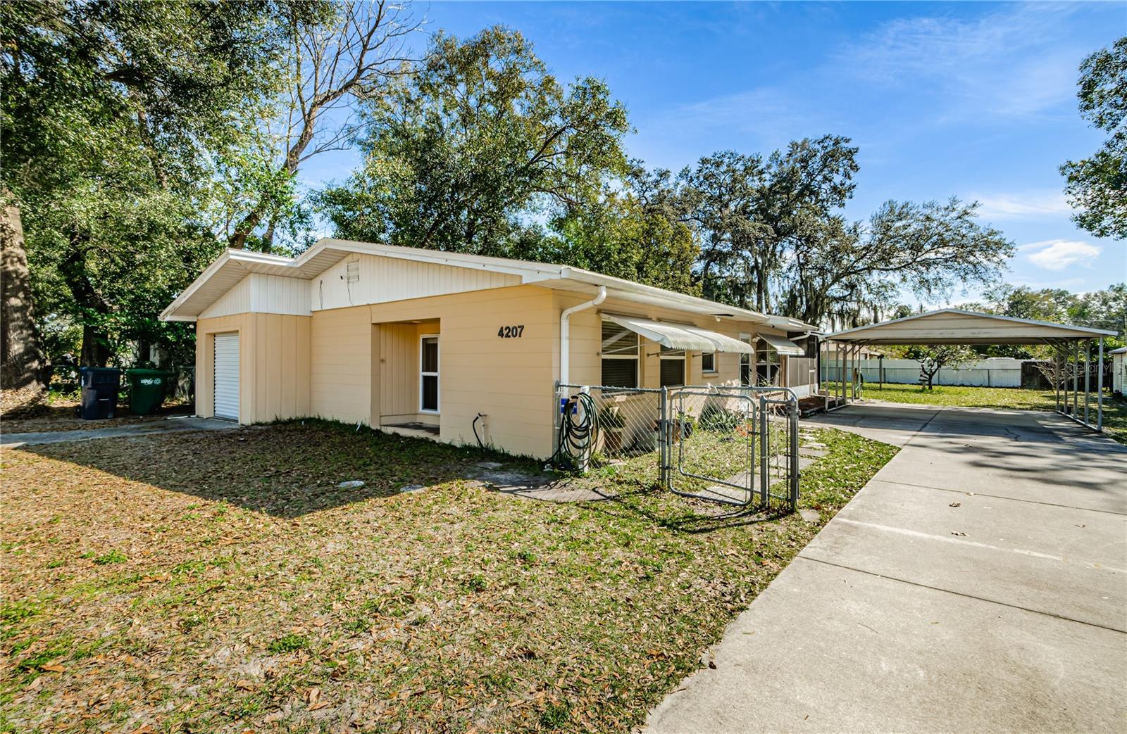 Welcome to the neighborhood of Temple Crest, where this home is situated on a rare spacious double lot with your very own orange tree in the backyard. With 2 bedrooms and a versatile office space that can easily be converted into a 3rd bedroom, 2 bathrooms and a screened in porch- this home offers flexibility to suit your lifestyle needs. There is a single car garage for all of your storage needs plus a wide carport & extended driveway offering plenty of room for extra cars, RV’s or boats. Bring your toys! The open kitchen features updated stainless steel appliances and plenty of storage. Convenience and comfort are seamlessly integrated into the living experience with easy access to both Interstate 275 to the West and I-75 to the East via Fowler or Hillsborough avenues. One of the standout features of this property is its proximity to iconic attractions such as Busch Gardens, Adventure Island & USF making this an ideal location for AirBnB/VRBO or long term rentals. For nature enthusiasts, the long winding Hillsborough River is within easy reach, offering a serene escape for leisurely strolls and outdoor activities. The home's functionality is further updated with the HVAC new in 2018, a new roof completed in 2022, and furnished with your own washer and dryer. Whether you're drawn to the vibrant local attractions or seeking a tranquil retreat by the river, this Temple Crest gem offers the perfect blend of location, comfort, and pride of ownership. Don't miss the opportunity to make this house your cherished home.