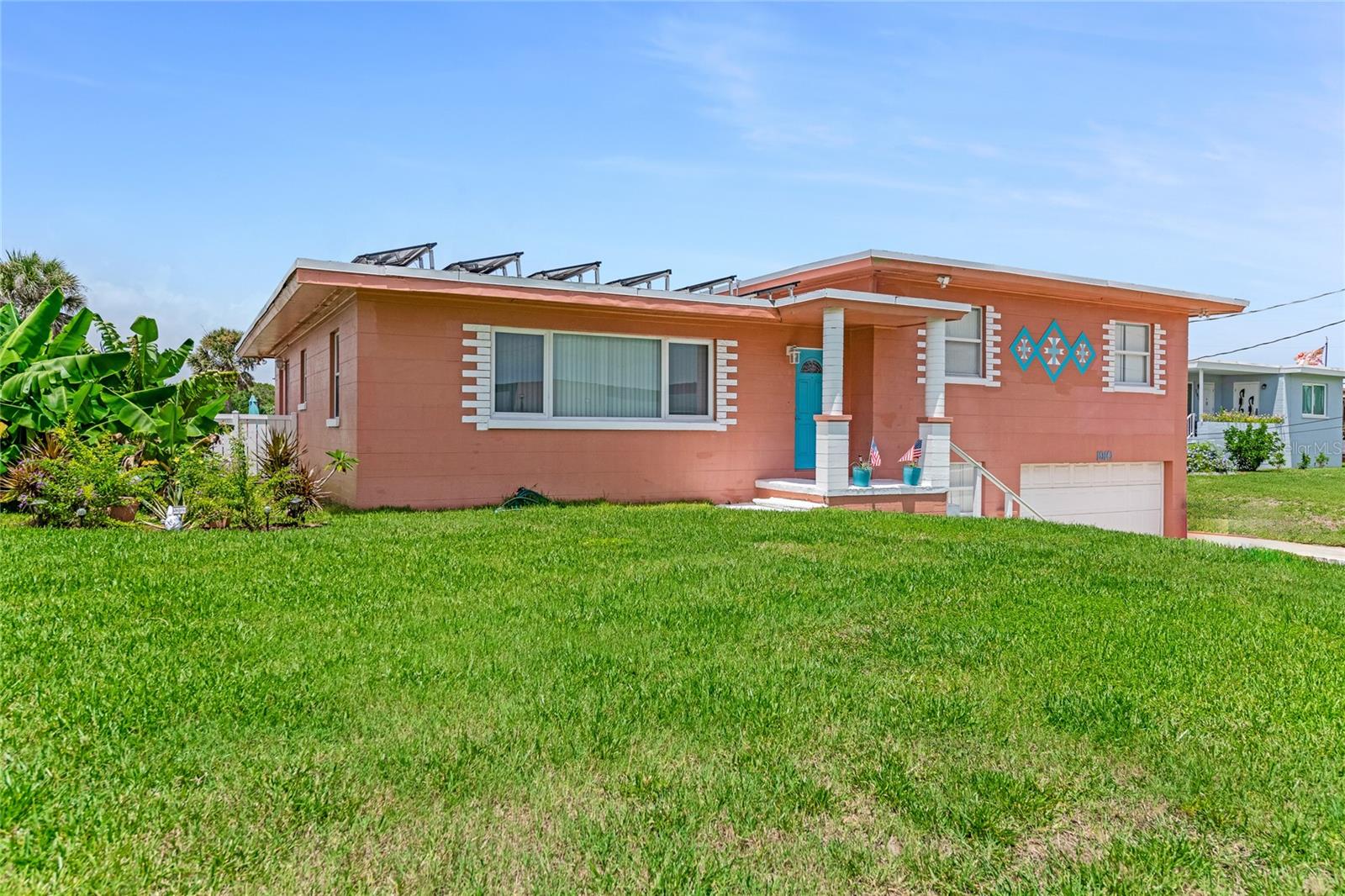 WOW - finally an OASIS that has been updated, beachside POOL home, that never flooded & sits up, on a high dune that is ready for your family & cars & RV!!! The kitchen has beautiful TEAK counters, SS farm sink plenty of cabinets, a dedicated huge spice rack & a walk in pantry with a barn door. Right next to the kitchen is a 2nd barn door that leads to a spacious office over looking the backyard. The bedrooms are all spacious with huge closets & primary bedroom has a brand new walk-in shower with 2 sets of jet controlled shower heads for 2 people!!! Tons of storage throughout the home plus an oversize 2 CAR GARAGE with an extended area in the back for all you toys. Now when you step out to the back yard you'll find an OASIS with a 4ft pool, a jetted hot tub under a pergola, and KITE STYLE SHADE SAILS that helps keep the hot sun at bay... Roof was done in 2016 & A/C-5 years new, plumbing & electrical updated. The WORLDS MOST FAMOUS BEACH is ACROSS THE STREET & NO HOA FEES!!!Did I mention there are 36 panels to help you save on electricity for the whole house - Its a Sunnova lease $245 month for 10 years... and you only pay FPL $9-58 a month for you electric bill...amazing deal!!!