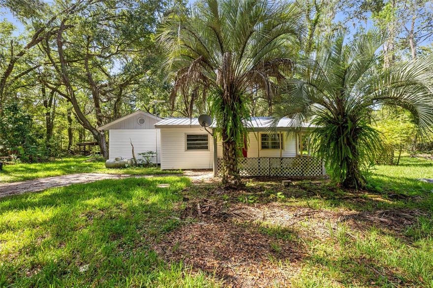 Cozy cottage home that is perfect for INVESTORS or as a starter home! Tons of privacy in a beautiful setting. The METAL ROOF was recoated 8 years ago and the interior has been UPDATED. The exterior VINYL SIDING was also replaced. This home sits on 1.66 acres with power septic for a mobile home. Located just minutes from Gainesville Regional Airport and not too far from shopping, this is country living that's not too far out!