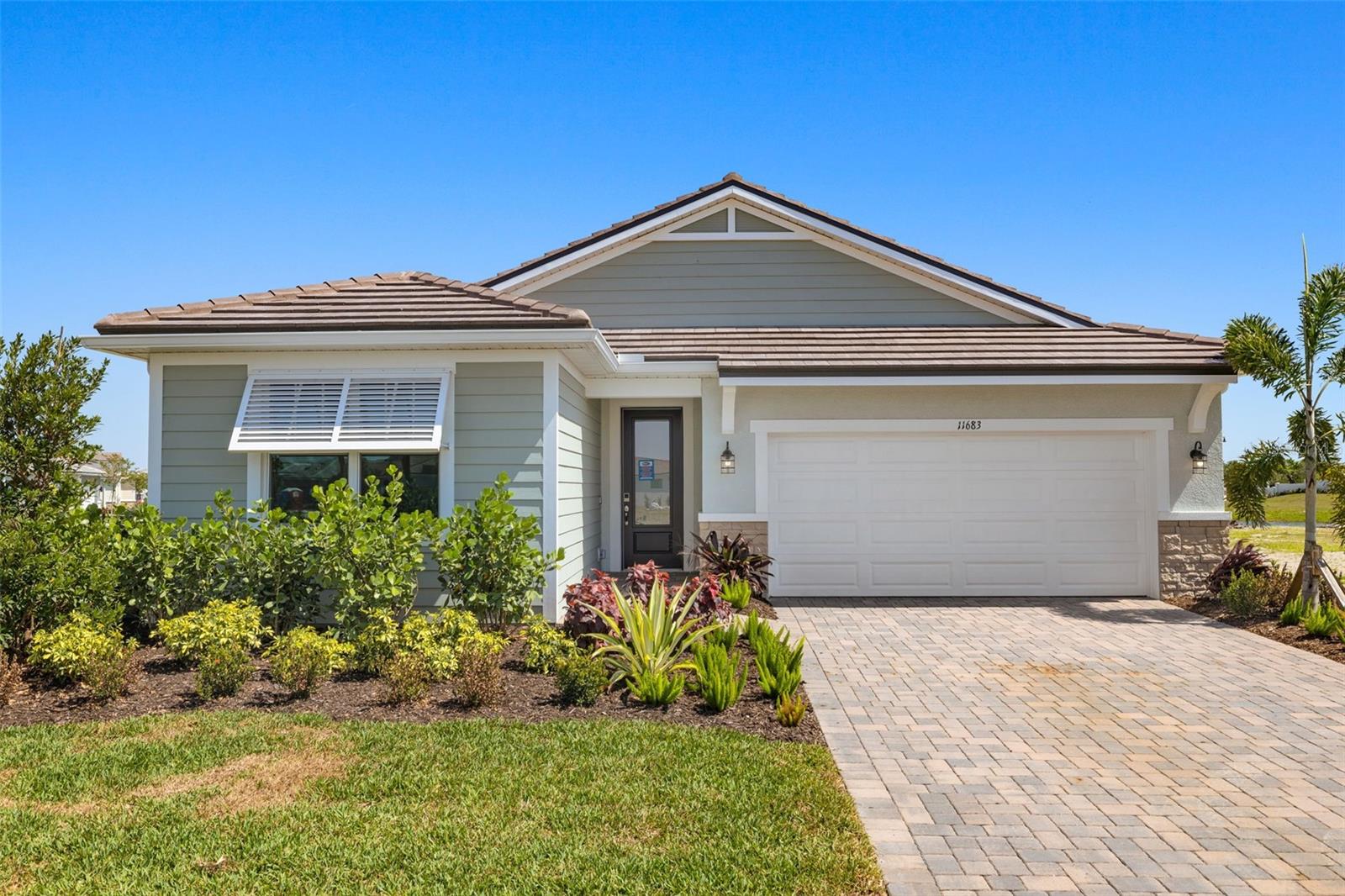 The Sage Coastal exterior is a single-family home with 2,193 sq. ft. has 2 bedrooms, a study and 2 and half baths. The welcoming foyer has convenient powder bath on the way to the open concept living area. This magnificent space is full of natural light, thanks to numerous windows and a 12-foot multi-sliding glass door leading to the covered lanai, which has been extended, and covered, which is perfect for enjoying the Florida lifestyle. The open space of the combined dining area and Great Room are perfect for relaxing or entertaining. The luxurious owner’s suite offers an expansive walk-in closet, linen closet and bath with a large shower, with bench seat. Bedroom two has its own private full bath, and linen closet. The garage has room for storage it comes with a garage door opener. This home has impact windows and doors, tile roof, and paver driveway. This Smart Home includes an Ecobee Smart Thermostat - Amazon Alexa compatible, Video Doorbell - with app, video recording and 2-way communication and ClareOne Touchscreen Panel! Wellen Park's only 55+ Community featuring future Amenity Center (21,000 sq ft) with 8 Pickle Ball Courts, 1 Stadium Court, 2 Pools (1 lap pool/1 resort style pool), State of the Art Fitness Facility, Bar and Cafe overlooking pools, dog park, Outdoor Exercise Lawn, Hot Tub, Full Time Lifestyle Director and so much more! Just minutes from beaches, Downtown Wellen Park, restaurants and shopping via golf cart/bikes or walking. Pricing, dimensions and features can change at any time without notice or obligation. Photos, renderings and plans are for illustrative purposes only and should never be relied upon and may vary from the actual home.