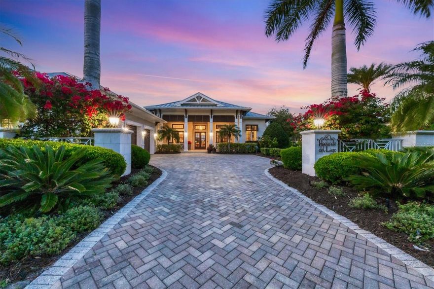 Experience luxury at 16023 Topsail Terrace, where every aspect of this home has been meticulously crafted. As you enter through the grand foyer, you are greeted by voluminous ceilings with custom trim and an accent wall with pillars. The dining room features a stunning glass-faced wine display with custom shelving, a shiplap wall, and exquisite lighting, perfect for entertaining guests in style. The den offers a tray ceiling, crown molding, and a custom built-in workstation. Glass French doors add a touch of elegance and provide privacy when needed. In the living room, a soaring vaulted ceiling with custom beams creates a grand ambiance, while pocketing sliders with windows above offer panoramic views of the outdoor oasis. The built-in media center with lights and storage, along with the built-in wine display, add to the luxurious feel of the space. The kitchen is a chef's dream, featuring an enormous central island with a granite countertop, storage and seating, stainless steel Wolf appliances, and ample soft-close cabinetry. The climate-controlled wine display and beverage drawers, separate Sub-Zero fridge and freezer, and stunning vent hood add to the kitchen's appeal. The informal dining area offers zero corner sliders and a dry bar. The primary bedroom is a retreat featuring two custom walk-in closets. An amazing sitting area awaits, surrounded by large windows adorned with plantation shutters. The high vaulted ceiling with exposed beams adds to the grandeur of the space, creating a feeling of openness and sophistication. Private access to the lanai allows for easy outdoor enjoyment and relaxation. Step into the primary bath, where stone floors complement the stone counters, a spacious vanity offers amazing storage options, a freestanding tub is highlighted by windows and art niches, while a courtyard with an outdoor shower with multiple shower heads, connected to the indoor shower, provides a refreshing experience. Two additional well-appointed guest suites within the main house add to the functionality. Step outside to the lanai to find shell stone pavers, an outdoor kitchen with a fridge, sink, and grill, covered and uncovered seating areas, and remote-controlled screens. The sunken fire pit, facing the pool with a lake view, creates a cozy atmosphere. The heated saltwater pool and spa with two fire bowls, along with the spacious yard and pergola overhang, make the outdoor space perfect for relaxation. The casita provides additional living space, with a kitchenette with beverage cooling drawers, a dishwasher, sink and cabinetry, a bedroom, and a full bath. A pool bath adds convenience for guests. Other features of the home include engineered hardwood, impact windows and doors, a mini-split in the garage with built-in storage, a whole-house generator, a mosquito-repellant misting system, and smart features throughout. This home offers the perfect blend of luxury and functionality, creating an exceptional living experience. The Lake Club offers a wealth of amenities, including grand clubhouse with a restaurant and bar, two resort-style pools, a fitness center, a massage and skincare room, a gaming and lifestyle center, and various sports facilities. This location is surrounded by top-rated schools and is a short distance away from dining, entertainment, and shopping, including the popular UTC Mall, Lakewood Ranch Main Street, Waterside Place, and more. Note: There is a one year whole home warranty including pool and spa.