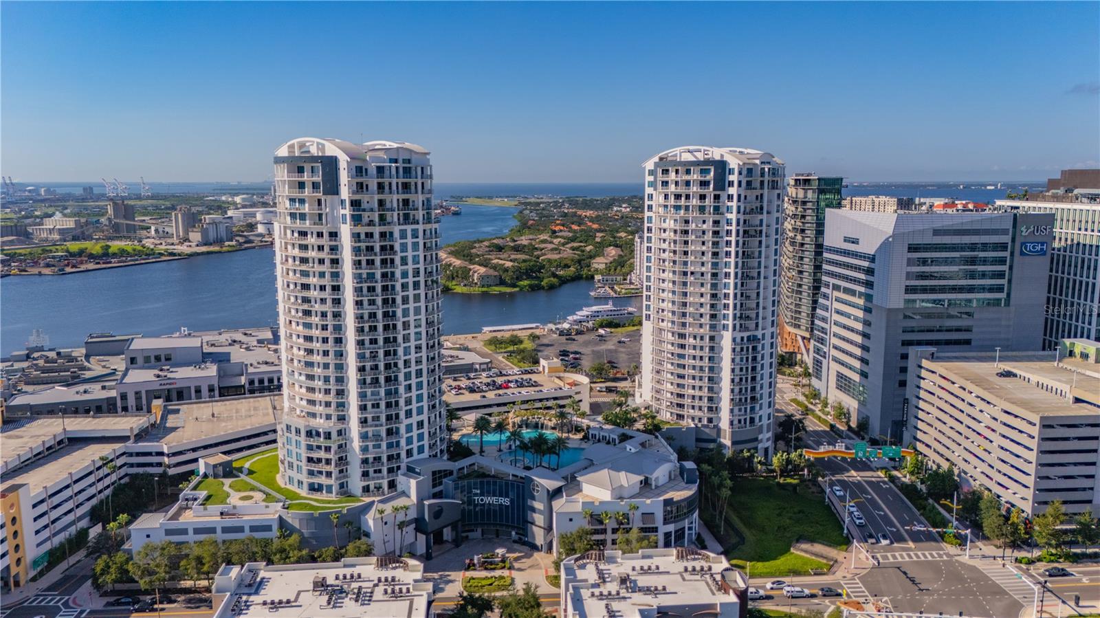 Welcome to this rarely available 9th floor residence at the Towers of Channelside. The 9th floor is a transition floor, making it the only floor with soaring 12-foot ceilings, a feature that enhances the sense of openness and light throughout the home.
The open concept design includes a modern kitchen with granite countertops, stainless steel appliances, and sleek cabinetry, seamlessly connecting to the living and dining areas. The spacious primary suite features a spa-like bath with dual vanities and a walk-in shower. The primary bedroom also features plenty of storage with a full walk-in closet, secondaery closet & linen closet. The second bedroom also features a large walk-in closet and boosts its own en-suite bath with walk in shower. There is also a separate half bath for added convienence and privacy while entertaining guests. The home has also been freshly repainted from head to toe.
A standout feature of this residence is the massive private balcony, providing direct views of the resort-style pool deck and cascading waterfalls. From this level, the balance is perfect: enjoy sweeping westerly views of the downtown Tampa skyline while also experiencing the tranquil sounds of the waterfall flowing over the pool. It’s a combination unique to this specific location on the 9th floor.
The location is just as impressive. Situated in the vibrant Channelside District, you are steps from Sparkman Wharf, Water Street, Amalie Arena, Tampa Riverwalk, and some of the city’s best dining, shopping, and entertainment venues.
This 9th floor condo is a true lifestyle property offering rare features, resort-style amenities, and one of the best locations in Tampa. Don’t miss the chance to own this exceptional home in one of the city’s most sought-after communities.