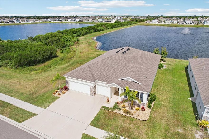 Discover this stunning 4-bedroom, 3.5-bathroom waterfront home in the desirable Shell Cove community of Ruskin. From the moment you arrive, you'll be greeted by mature landscaping and the impressive oversized 3-car garage.
Step inside to an elegant, open-concept design featuring tall ceilings and ceramic tile throughout. The spacious kitchen and family room combination is perfect for entertaining, anchored by a huge island/breakfast bar, sleek dark wood cabinetry, and stainless steel appliances. A bright dinette area sits conveniently adjacent to the kitchen.
The large 3-panel sliders in the main living area perfectly frame the peaceful pond views out back, bringing the serene waterfront setting into your home. The home also includes a versatile bonus room and a large, central laundry room.
The thoughtful split-bedroom layout offers exceptional privacy. The primary suite is a true retreat with an en suite bathroom and a large walk-in closet. A rare find, the second bedroom also features its own en suite bathroom and walk-in closet, making it an ideal guest or in-law suite. The additional bedrooms are generously sized.
Community Amenities: Enjoy the best of community living with a fantastic array of amenities, including a Clubhouse, sparkling Pool, Playground, and Dog Park. The neighborhood features Sidewalks for pleasant strolls, a convenient Community Mailbox center, and is secured by Deed Restrictions.
This home is an absolute must-see for those seeking waterfront living, luxury amenities, and a vibrant community lifestyle!