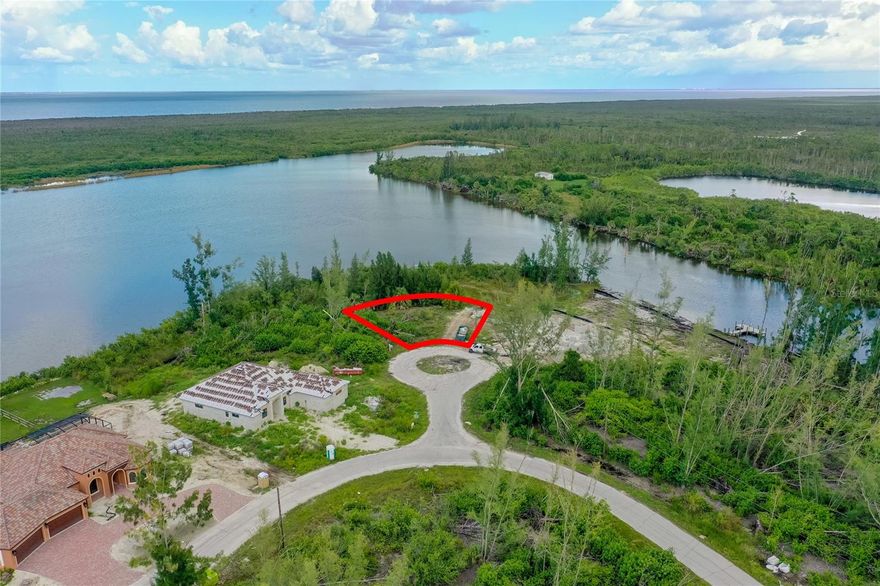 High and Dry!! No worries of flooding on this lot! One of the best views in South Gulf Cove! Sailboat access, Large Tip Lot with extra Environmental area, and large composite dock! An environmentally sensitive Area becomes your backyard, but no structures can be built on it. Feels like a double lot! Perfect to build your dream home. Buy now and build later.  It's all about the wide water view of Long Lagoon within South Gulf Cove. Waiting for the perfect lot? Here it is. Located on a cul-de-sac and in a great location not far from Boca Grande. Brand new homes are being built all around it to make it a nice new neighborhood. This property backs up to a Greenbelt! This is an area of high-end new homes. All public utilities are available. This is truly a rare property that will become your piece of paradise.