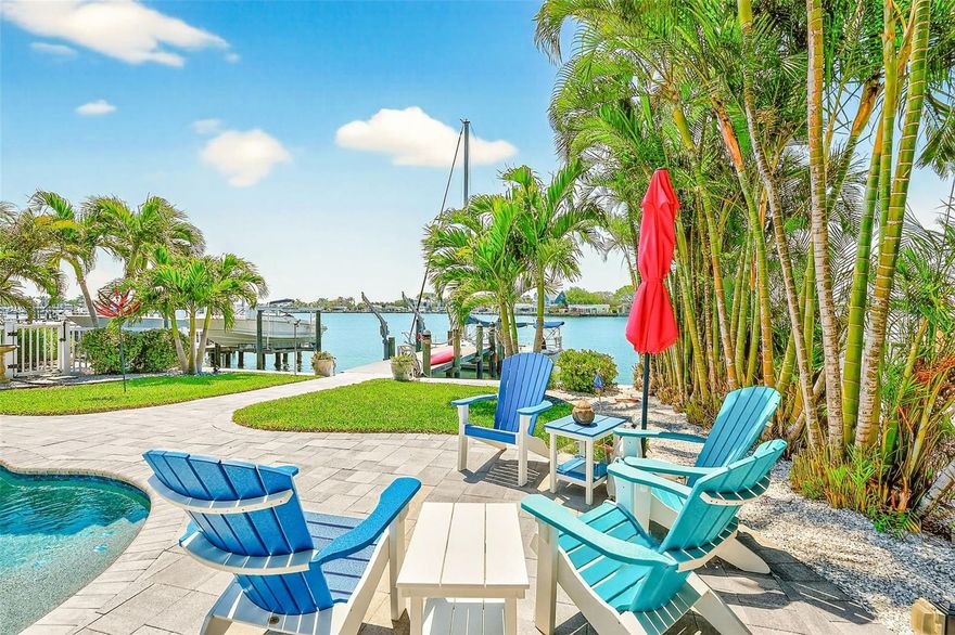 Spectacular two-story waterfront home in Indian Rocks Beach. This updated, move-in-ready home has been thoughtfully designed for indoor-outdoor living. Three bedrooms and three bathrooms, the primary bedroom and en-suite bath encompass the second floor. The second-floor outdoor patio is perfect for sunrise or sunset. The open floor plan on the main level is filled with abundant natural light and creates a bright, airy ambiance. The spacious kitchen boasts ample counter space and a layout that encourages effortless meal preparation and entertaining. Stepping outside, the property's lush landscaping and tropical oasis setting creates a relaxing atmosphere with coveted southern exposure. The expansive outdoor living areas, includes an inviting patio, private salt cell pool and jacuzzi, offering the perfect space to enjoy the coastal lifestyle and scenic waterfront views. The dock provides direct water access to the bay and Gulf. Out front, the spacious driveway ensures ample parking for guests, complementing the overall ease and comfort of this coastal living experience. Come and take a look today!