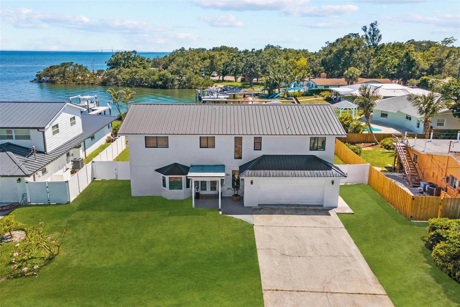 Coastal Elegance Meets Modern Luxury in This Waterfront Oasis. Welcome to this stunningly reimagined two-story waterfront estate, where sophistication and lifestyle converge. Boasting 4 bedrooms, 4.5 bathrooms, and a spacious 2-car garage, this fully remodeled residence is nestled along the tranquil bay with direct ocean access, complete with a private boat dock and a resort-style pool. Step inside to discover a flawless blend of contemporary design and timeless craftsmanship. The interiors are drenched in natural light, with expansive windows framing serene water views. Every bathroom is a showcase of luxury—floor-to-ceiling artisan tilework, frameless glass enclosures, and sleek, spa-inspired finishes. The second-floor layout offers the ideal balance of privacy and connectivity. A split-bedroom plan flows into an oversized 1,100+ SF waterfront balcony, perfect for entertaining or simply enjoying daily sightings of dolphins and passing
yachts. The primary suite is a retreat of its own, featuring a spa-like en suite bath with a stand-alone soaking tub, walk-in shower, and a generous custom walk-in closet. Downstairs, a gourmet chef’s kitchen serves as the heart of the home—complete with premium appliances,
custom cabinetry, and ample space for culinary gatherings. Just beyond, the elegant living area opens seamlessly to the pool deck through wide sliding glass doors, inviting the outside in. Whether you're sunbathing on the brand-new upper terrace, hosting guests waterside, or casting a line off your private dock, this is Florida living at its finest. Don’t miss the opportunity to make this exclusive waterfront residence your forever home. Private showings available by appointment only.