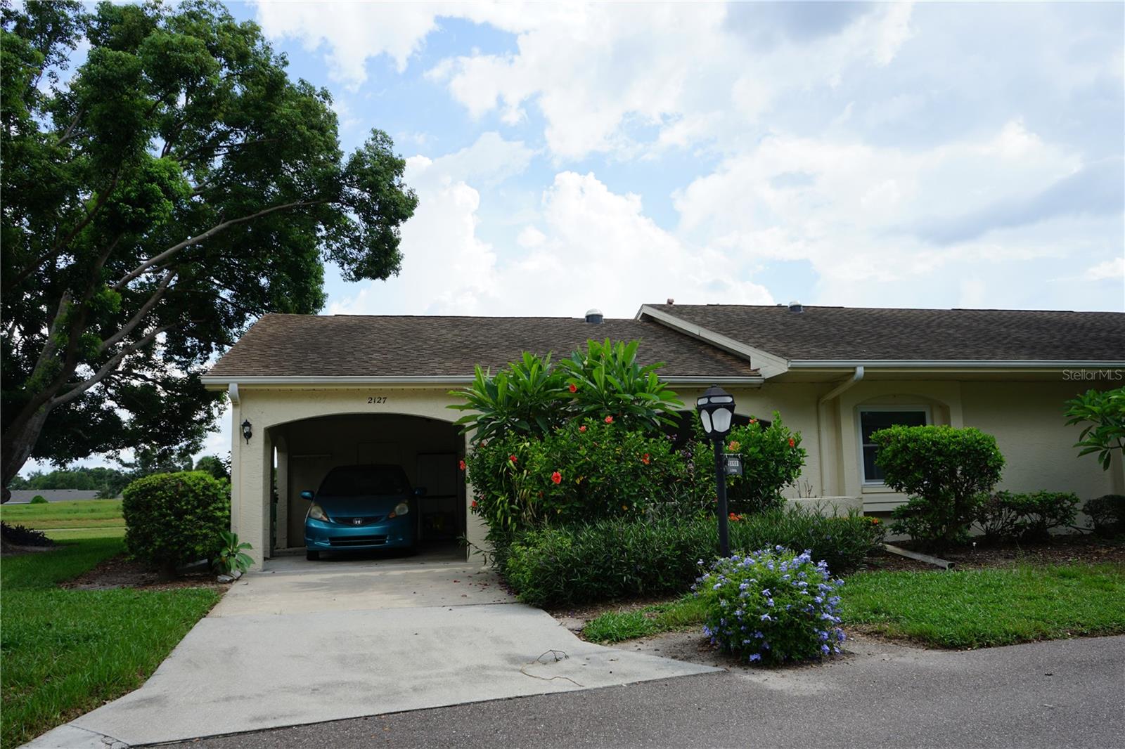 This attached home is located in Kings Point, one of Florida's best retirement communities where your month fee covers just about everything making life here easy. You have a driveway long enough for 2 cars with one under the roof, There is a golf cart garage or use it for bikes and beach gear too. The front screened porch is nice and private with the flowering bushes then you enter into the foyer. The hallway to your right takes you to the galley style kitchen with nice cabinets and plenty of counter space. Loads of closets in the hallway along with the laundry area and the guest bedroom and full bath are here too. Taking the hallway straight you come to the dining room and the breakfast/office space at the end of the kitchen. There you'll find the owners bedroom and en suite bathroom with a walk in shower. The living room is at the back to enjoy the water and greenspace views with another screened porch the enjoy the breeze while watching the birds. This community has lots to offer and is within an hour of 3 airports and multiple beaches and entertainment for all ages.