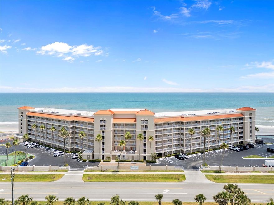Wake up to endless Atlantic Ocean views in this spectacular corner unit at the prestigious Sandpiper complex. This fully furnished, 1,985 square foot luxury condo offers an unparalleled beachfront lifestyle with panoramic water vistas that stretch to the horizon. The open-concept floor plan maximizes the stunning ocean views while elegant tile flooring, sophisticated crown molding, coffered ceilings, and custom plantation shutters create an atmosphere of refined coastal luxury. Floor-to-ceiling glass sliders seamlessly connect the interior living space to your private oceanfront balcony, where endless Atlantic views become your daily backdrop.
The gourmet kitchen features spacious granite countertops and an oversized island with convenient bartop seating, creating the perfect space for both casual dining and entertaining guests. The luxurious master suite provides a private sanctuary with direct balcony access to those captivating ocean views, complemented by an expansive en suite bathroom featuring a separate soaking tub and walk-in shower. Two additional bedrooms are thoughtfully furnished to accommodate guests comfortably, with one featuring a queen bed and the other equipped with twin beds, ideal for families or visiting friends. Three full bathrooms throughout ensure privacy and convenience for all occupants, while in-unit laundry with a stackable washer and dryer adds modern convenience to this turnkey furnished rental.
The Sandpiper complex elevates your coastal experience with exceptional resort-style amenities including two sparkling swimming pools, a relaxing spa and hot tub, tennis court, shuffle board, and putting green. New Smyrna Beach offers the perfect blend of tranquil beach living and convenient amenities, with this prime oceanfront location providing direct beach access and breathtaking sunrise views every morning.