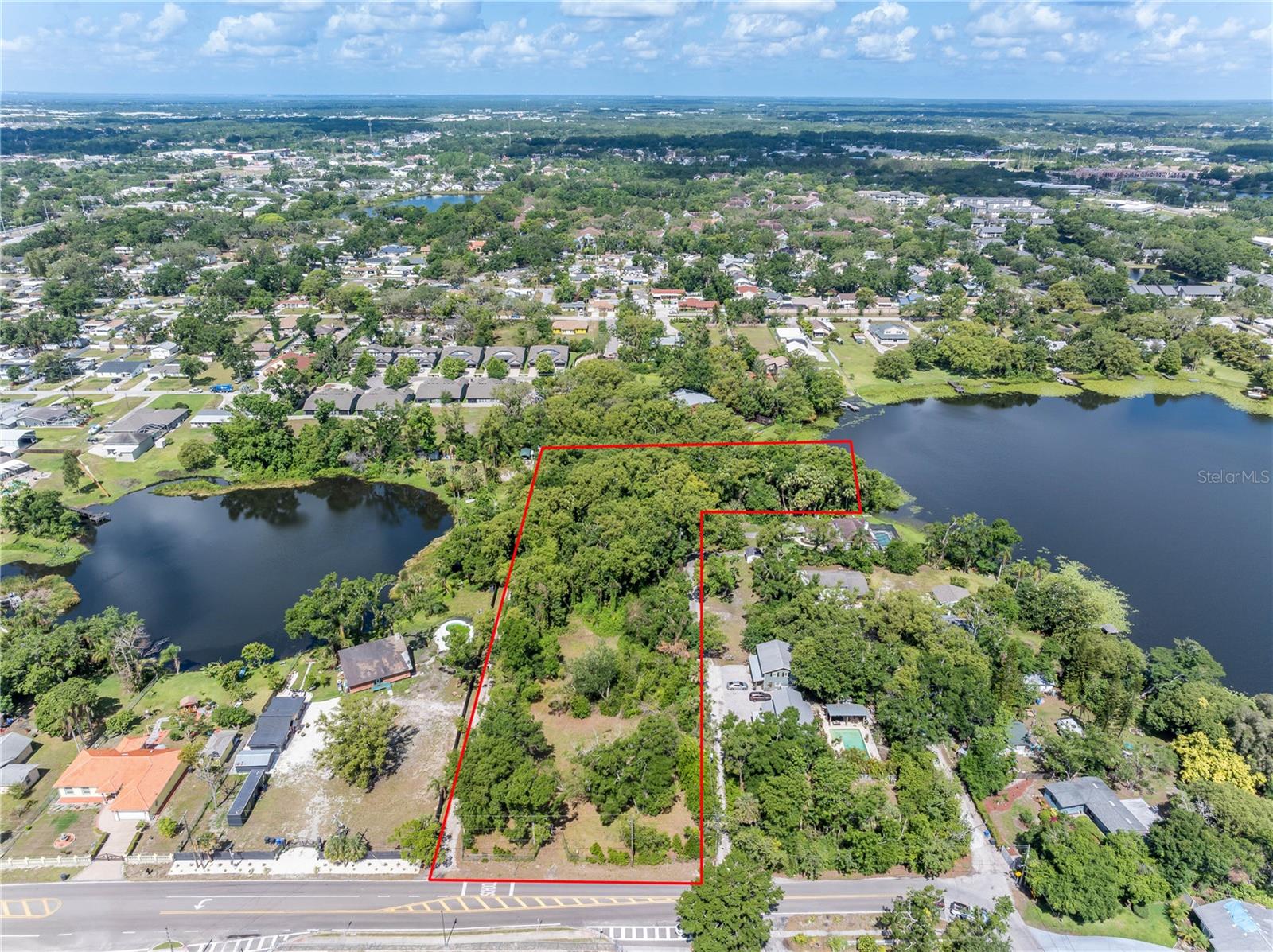 Escape to your own paradise! We are excited to present a breathtaking large lot nestled in the heart of nature in West Tampa close to hundreds of amenities, offering unparalleled views and direct access to a serene private lake, Twin Lake. This is a rare opportunity to own a piece of land and water that combines tranquility, beauty, and endless possibilities. And can you believe it is in flood X!? Almost the WHOLE LOT is buildable and a well is already present from the recently demolished home!! With the purchase of this lot, ownership of a slice of the Lake is yours too! Enjoy ample space to build your dream home, vacation retreat, or investment property. The generous size allows for plenty of outdoor activities and landscaping options. Experience the joys of lakeside living with exclusive access to a pristine private lake perfect for fishing, kayaking, or simply relaxing by the water’s edge. Surrounded by lush trees and vibrant wildlife like majestic peacocks, this lot offers a peaceful escape from the hustle and bustle of city life, while still being conveniently close to it! Opportunities like this are rare. Contact us today to schedule a viewing and take the first step toward making your dream a reality. Your private oasis awaits!