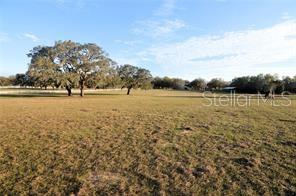 10 ACRES of rolling hillside located in a private EQUESTRIAN ENCLAVE. You feel like your in the hills of Ocala on this 10 acre parcel located in Trilby Trails, a deed restricted equestrian community minutes north of Dade City. Spectacular sunsets, undulating hillsides with great views, and grandfather oaks make this property a magnificent find. Deed restrictions include access to community riding trails and excludes mobile homes. Surrounding estates are 5-20 acres with large estate style custom homes. Property features include boundary fencing with "no climb" horse friendly fencing on 3 sides with top rail and board fencing on the 4th side, a 38'x40' professionally constructed pole barn, and a 16'x24' run-in shelter. Located at the end of a dead end private road with no thru traffic. Easy commute to Tampa and only 55 minutes to Tampa International Airport. Parcel could possibly be split into (2) 5 acre parcels. Verify with Pasco County.