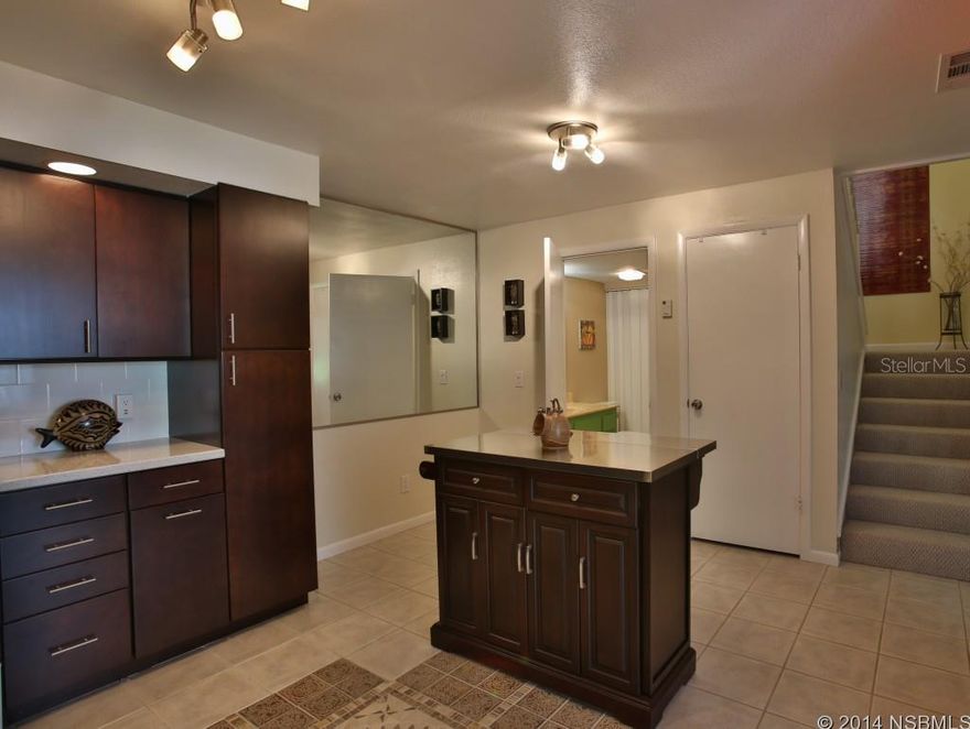 MOVE TO THE ISLAND! Orchids and refreshing tropical surroundings envelope this 2BR, 2.5 BATH BEACH HOUSE in a RARE hardwood ocean canopy across the street from oceanfront. This BOHEMIAN KEY WEST STYLE community is well established and meticulously maintained.  Early morning will find you enjoying coffee on newly reconstructed patio right off your Master BR listening to doves nestled in your tropical butterfly garden.  No sounds from Atlantic Avenue. This unit is nestled in the MOST TRANQUIL area of the community.  2013 your new contemporary kitchen was completely renovated down to the studs with updated electric and using the finest craftsmanship and materials throughout. Enjoy details like the new knockdown ceiling not found in other âupdatedâ units in the community.  High end SS appliances were all purchased 01/ 2013, and the new Carrier AC was purchased 11/12; all are under warranty.  12 x 12 ceramic tile floors with mosaic inlay are stunning/ easy to keep clean.  Berber carpet in coordinating natural color is in LR/BR for comfort, easy upkeep.    Bath/laundry on 1st flr.  Additional storage for your beach toys can also be âsecured ownerâs closetâ if leasing unit with award winning on-site property management.    Master Walk-in/2 full closets in the guest room.  Colors of the beach coordinate your neutral high end furnishings.  Not paint only âupgradeâ in the Bahamian Club!  Your new beach home is priced well for the true renovations, superior location, lovely furnishings and island details.  CB homes located on the island, and directly across the street from the crystal waters and no-drive beach bring twice this asking price.   Amenities include sparkling pool, new tennis courts, shuffleboard and more. One of the most reasonable fees on beach side. Reserves are healthy!  Within a short walk you will find a grocery store, fresh produce, a beach store and the finest International Deli in FL.  No need for a car on this end of the beach once you arrive ;Water: City