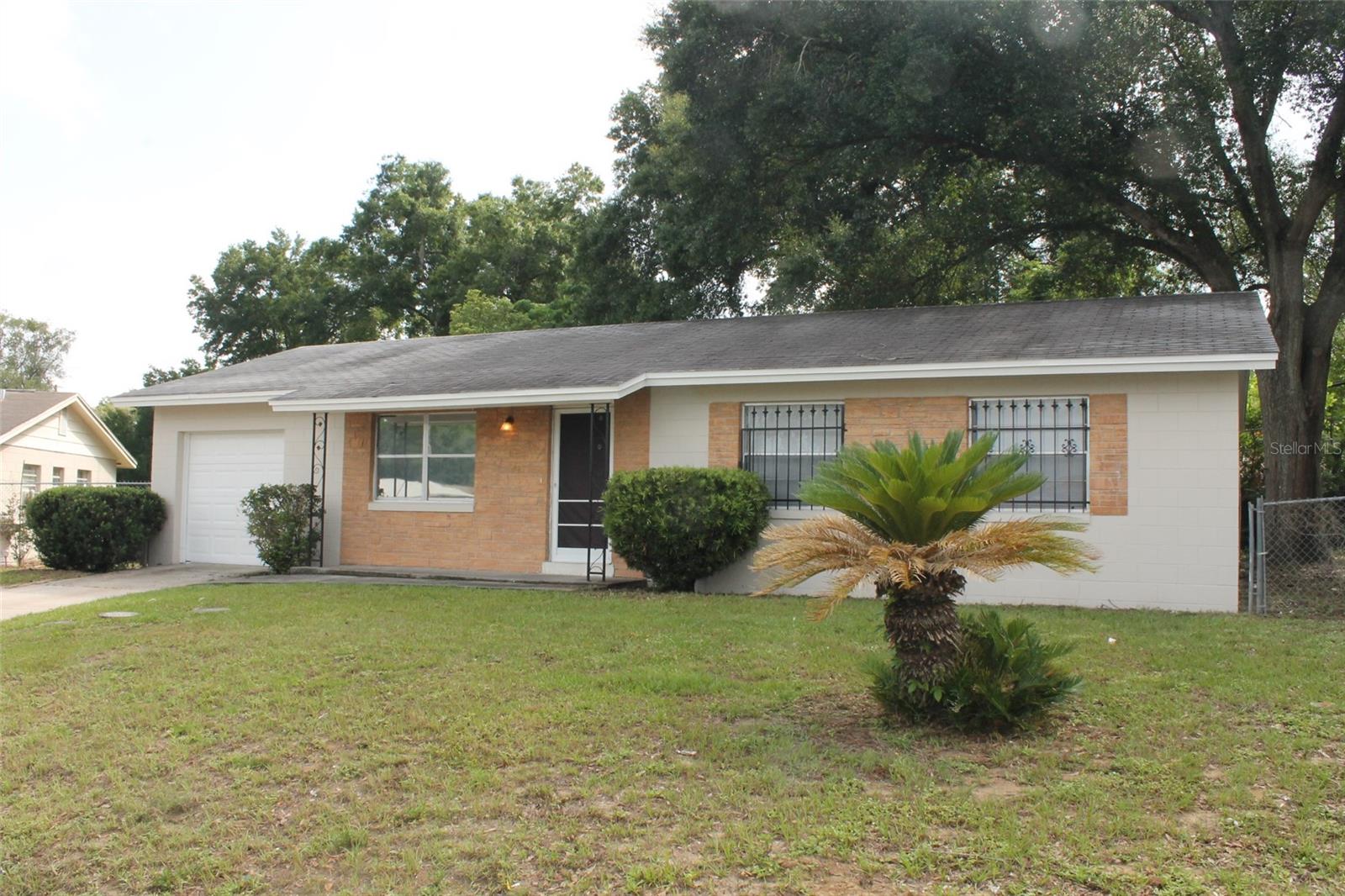 This cute 3BR 1.5BA single family home has 18" ceramic tile floors throughout for easy upkeep. There is plenty of natural lighting throughout with windows in each room! The living/family room is spacious for everyday living. A separate dining area off the kitchen is perfect for your dining needs. The kitchen offers two pantry closets and plenty of cabinet space, gas range and standard refrigerator complete this space. Ceiling fans in each room! A one car (manual opening) garage with W/D hookup. This home is nestled on a corner lot with plenty of space in the fenced yard! Available for move in December 2025.