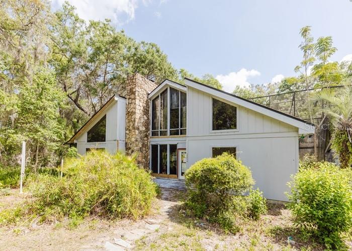 Auction Property. AUCTION. This unique gem will require your renovation ideas. This fixer upper offers 3 beds, 2 baths, vaulted living room with fireplace, a separate dining area, and a large eat-in kitchen. The attached patio/pool-deck area is surrounded by mature trees offering water views, and ample space to relax and entertain. Home sits on approximately 2 acres and offers a detached garage for extra storage. A lot will be required to restore this gem, but well worth the effort. Come build some equity as you restore this retreat. CAUTION DECK area may be unstable. USE CAUTION throughout. Property utilizes WELL and SEPTIC system. Property is sold as-is with NO property disclosure or inspection reports.