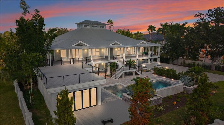 One or more photo(s) has been virtually staged. Welcome to one of Pinellas County’s most distinguished waterfront estates — an extraordinary blend of
privacy, luxury, and refined coastal living. Set on over 2 gated acres along the shimmering shores of St.
Joseph Sound, this spectacular residence has been thoughtfully enhanced with premium upgrades and
resort-caliber amenities.
Offering more than 4,100 square feet of beautifully refreshed interior space, the home features new
designer paint, elegant tile flooring, vaulted ceilings, and expansive open areas that capture natural
light and serene water views.
At the heart of the home, the gourmet kitchen showcases warm wood cabinetry, exotic granite
counters, Sub-Zero refrigeration, double ovens, induction cooktop, wine cooler, and warming
drawer—perfect for both intimate gatherings and high-end entertaining.
The home includes private bedroom suites with Jack-and-Jill baths, offering comfort and convenience.
The impressive large master suite is a true haven, featuring an electric fireplace and an oversized
walk-in closet with extensive custom built-ins for exceptional organization. A stunning 500-gallon
aquarium serves as a striking focal point, adding tranquility and sophistication to the living space.
Additional enhancements include an in-home gym and a full residential elevator, elevating daily living
with comfort and accessibility.
Step outside to your own private waterfront resort. The sleek, newly added lap pool is surrounded by
expansive patios and lush landscaping. Just beyond, the luxury outdoor cabana becomes the ultimate
gathering space, featuring dramatic nano doors that open entirely for seamless coastal indoor–outdoor
living.
For boating and water enthusiasts, the estate features a brand-new dock equipped with two boat lifts,
offering unmatched convenience and direct access to the Intracoastal and Gulf waters.
Car collectors will be impressed by the exceptional detached garage complex, offering parking for up to
10 vehicles, including RV parking, abundant storage, commercial-grade doors, and epoxy flooring. A
whole-home generator ensures peace of mind year-round.
On the lower level, the expansive bonus room with French doors includes a newly renovated full bath,
making it ideal for a guest suite, media room, office, studio, or flex space.
Combining unmatched privacy, modern upgrades, and resort-style amenities, this exceptional estate
offers a rare opportunity to enjoy true luxury coastal living in North Pinellas.
A timeless Gulf Coast masterpiece—designed for those who demand the best.