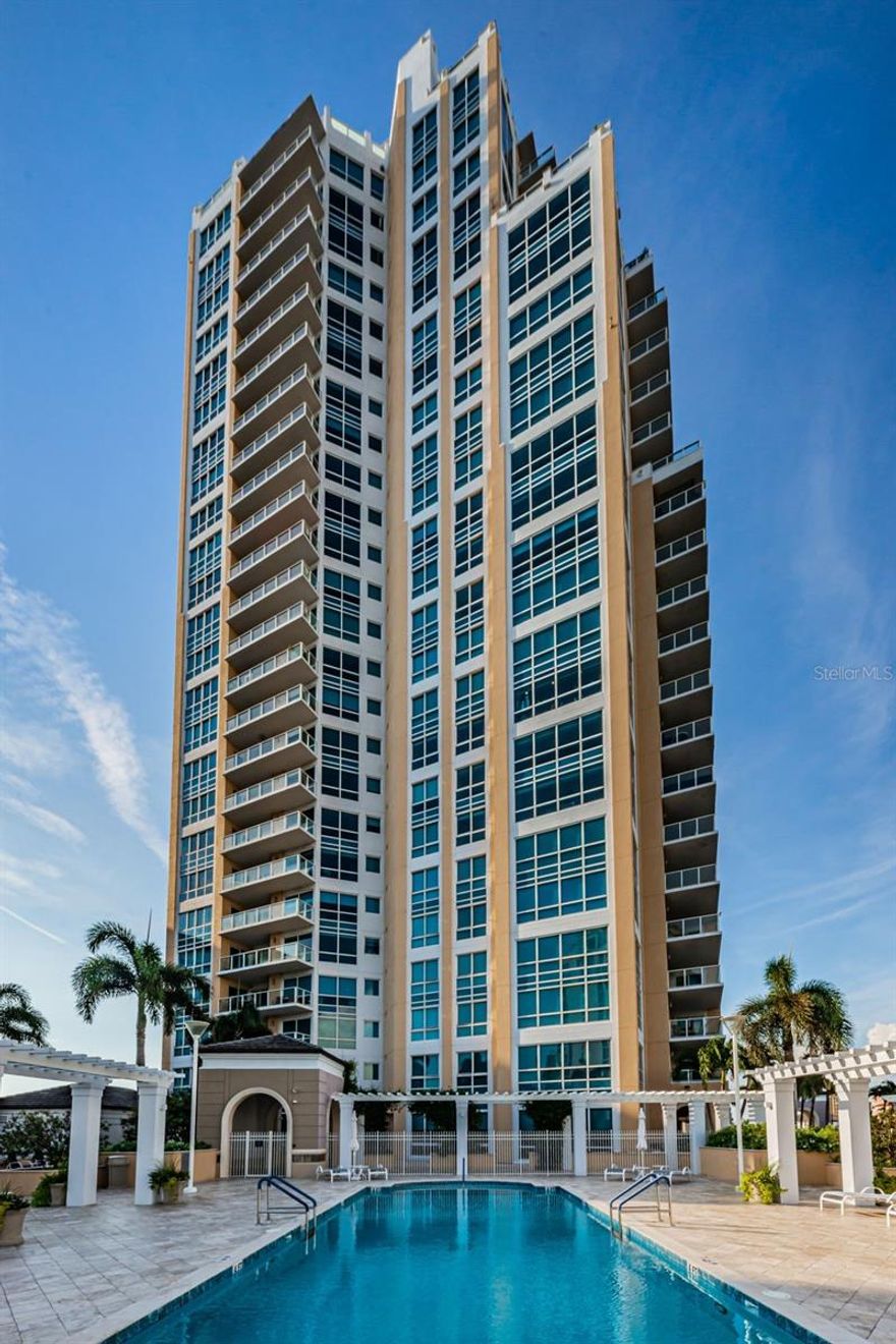 Located on the 7th floor in one of the most sought after buildings on Beach Drive, this 3 Bedroom, 3 bath residence with a private office provides a spacious and bright. open floor plan. As you step into your private foyer through the double doors off the elevator, you’ll be greeted by elegant porcelain floors and flowing light from the floor to ceiling windows with spectacular, panoramic views of Tampa Bay, Pier Park, and south to Albert Whitted Airfield. Remodeled in 2019, the home has new floors, lighting, custom closets, crown molding, and new shades and drapery on all windows. A large terrace with its sweeping views offers access from both the living room and owner’s suite. The truly remarkable chef’s kitchen features a 12’ island, custom cabinetry with elevator lifts, a 48” Gas Range, and GE Monogram stainless appliances. The en-suite owner’s Bedroom has an extra large walk-in closet and distinctive attributes of the remodeled bath include a free standing, deep soak tub, large shower and dual sink vanity. Two guest bedrooms, one of which is an en-suite, and a third separate bathroom provide plenty of space for family and friends. The office has built-in furniture with organizers and a rolling desk for added functionality. In 2022, a full house water softener and new washer/dryer were installed in the separate laundry room. An EV Charging Station has been added to the two side by side parking spots on the 3rd floor. The unit comes with a climatized storage room on the 2nd floor. 400 Beach Drive amenities include 24-hr concierge and a state-of-the-art fitness center with men & women's steam room, heated swimming pool & jacuzzi, outdoor grills, a covered outdoor fireplace and more. Call for your private showing of this striking residence.