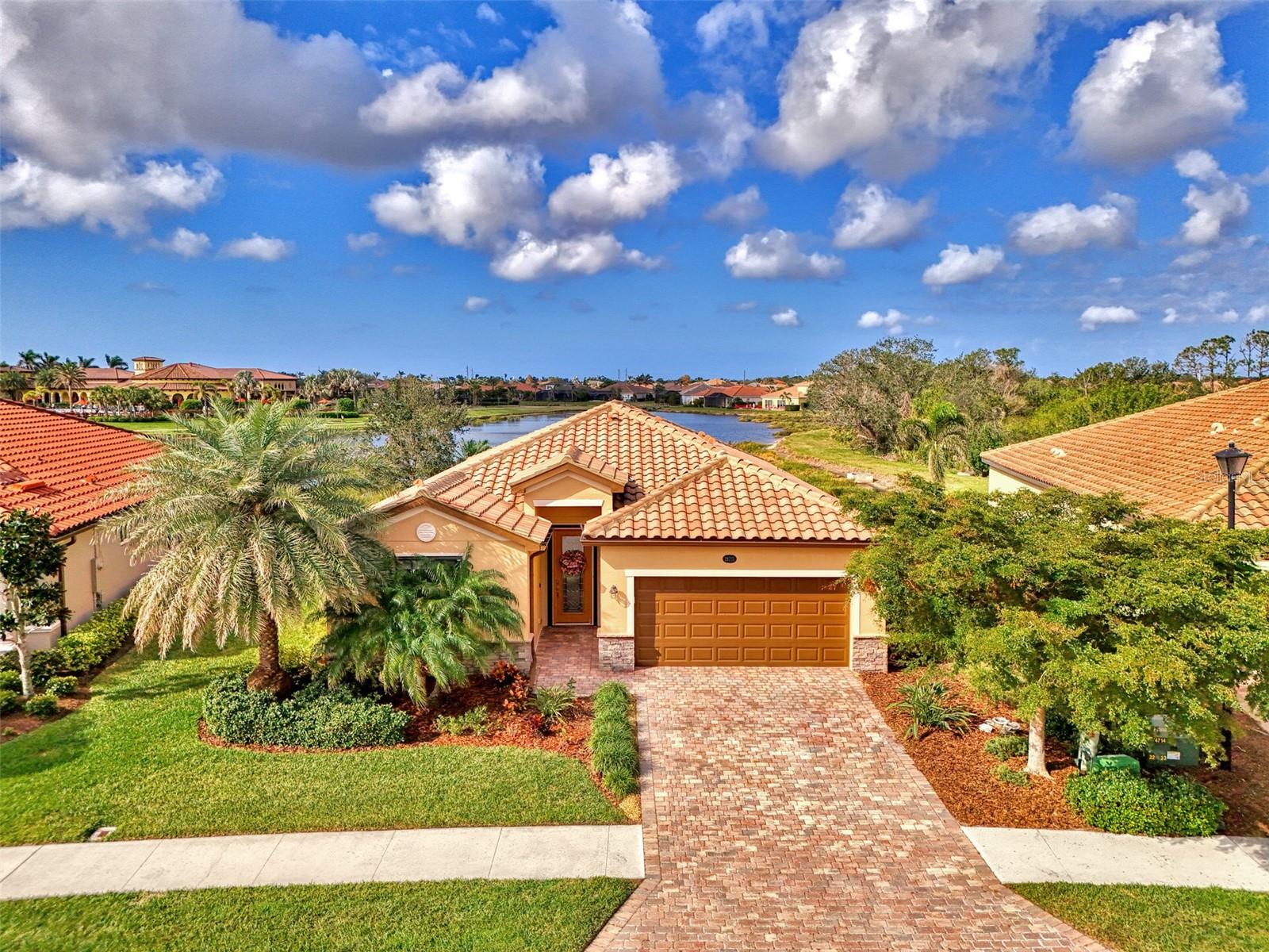 Luxurious Home with spectacular Waterview in Gran Paradiso at Wellen Park! Welcome to 20211 Granlago Drive, a stunning 4-bedroom, 3-bath home located on a premium lot with water and preserve view in the gated resort community of Gran Paradiso. This meticulously maintained residence offers the perfect blend of elegance, comfort, and convenience, just 7 miles from pristine Gulf beaches and steps from Downtown Wellen Park's vibrant shops, dining, and entertainment. Step inside to a grand, expansive entryway adorned with wainscoting and crown molding, leading to a spacious open-concept great room that seamlessly connects the living room, dining area, and kitchen. Enjoy beautiful tile flooring throughout, freshly painted kitchen cabinets, granite countertops, and a wood-accent ceiling in the living area that adds warmth and charm. A standout accent wall, remote-controlled blinds, and an elegant chandelier elevate the dining experience.
The primary suite is a private retreat featuring an accent wall, two generous walk-in closets, remote-controlled blinds, and a spa-like en suite bathroom with dual vanities, a soaking tub, and a separate walk-in shower. One guest bedroom includes its own en suite bath, while another is perfectly suited as a home office or den, complete with its own accent wall. Outside, your private oasis awaits—complete with a heated saltwater pool and spa, Kevlar electronic roll-down hurricane screens on the lanai. Enjoy peace of mind with accordion hurricane shutters on all windows and the front door, a new HVAC system (2025), new smoke detectors, and a central vacuum system. The garage features epoxy flooring and storage racks, and the exterior was freshly painted in 2024, with the roof, lanai, and driveway recently power-washed. Additional upgrades include Smart Home technology, a whole-house water softener, and an in-wall pest control system. Located in an X flood zone, this home offers both security and ease of living. Gran Paradiso is a resort-style community with 24-hour gated security, a grand clubhouse, resort-style pool, pickleball and tennis courts, a sauna, fitness center, playground, walking trails, and a full-time activities director to keep your calendar full and fun. Don't miss this rare opportunity to own this luxurious home and start living the ultimate Florida lifestyle.