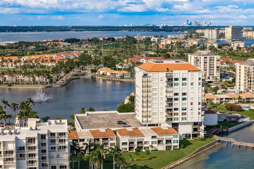 Perched high on the 9th floor of the distinguished Bahia Del Mar community, this original-owner 2 bedroom, 2 bath residence spans 1,240 sq ft and showcases breathtaking 180-degree panoramas of the Intracoastal Waterway, downtown St. Petersburg skyline, the lake and lush community grounds. Each room opens to wide-reaching water and skyline views that simply must be seen in person to fully appreciate.
Step inside to a kitchen that’s built for both style and function—with granite countertops, maple wood cabinetry, a travertine tile backsplash, a breakfast bar and tile flooring. The living areas and primary suite are finished in luxury vinyl plank flooring for an updated, elegant look. The primary bedroom includes a generous walk-in closet and direct balcony access. A dedicated laundry room with newer washer and dryer adds real-world convenience. All windows and sliding glass doors are fitted with automatic shades; furnishings are negotiable and all appliances are included. Amenities here are nothing short of resort-style—and the building’s offering is elevated even further: the newly updated fitness center in this building is being touted as “one of the best in the entire ­Bahia Del Mar community” with modern equipment and stunning water vistas. Just outside, the pool and spa area has been freshly resurfaced to deliver a pristine waterfront experience. Other highlights: fishing pier, walking paths, a secure building lobby, a 3rd-floor gathering room and game room for residents. The HOA fee covers nearly everything except electricity, and this building has passed its Milestone inspection. For those who want even more—residents have the optional access to the Isla Del Sol Yacht & Country Club with golf, tennis, pickleball, a marina and an engaged social calendar. Located just minutes from award-winning Gulf beaches, Fort DeSoto Park, downtown St. Petersburg and a quick drive to local airports, Bahia Del Mar perfectly blends Florida coastal lifestyle with convenience. While photos highlight much of what makes this home special, the views are even more captivating in person, offering a unique perspective of the surrounding waterways and skyline that words simply can’t capture. APPLIANCES INCLUDED: Refrigerator • Range • Dishwasher • Microwave • Washer • Dryer. MECHANICAL UPDATES: HVAC (2016) • Water Heater (2022)