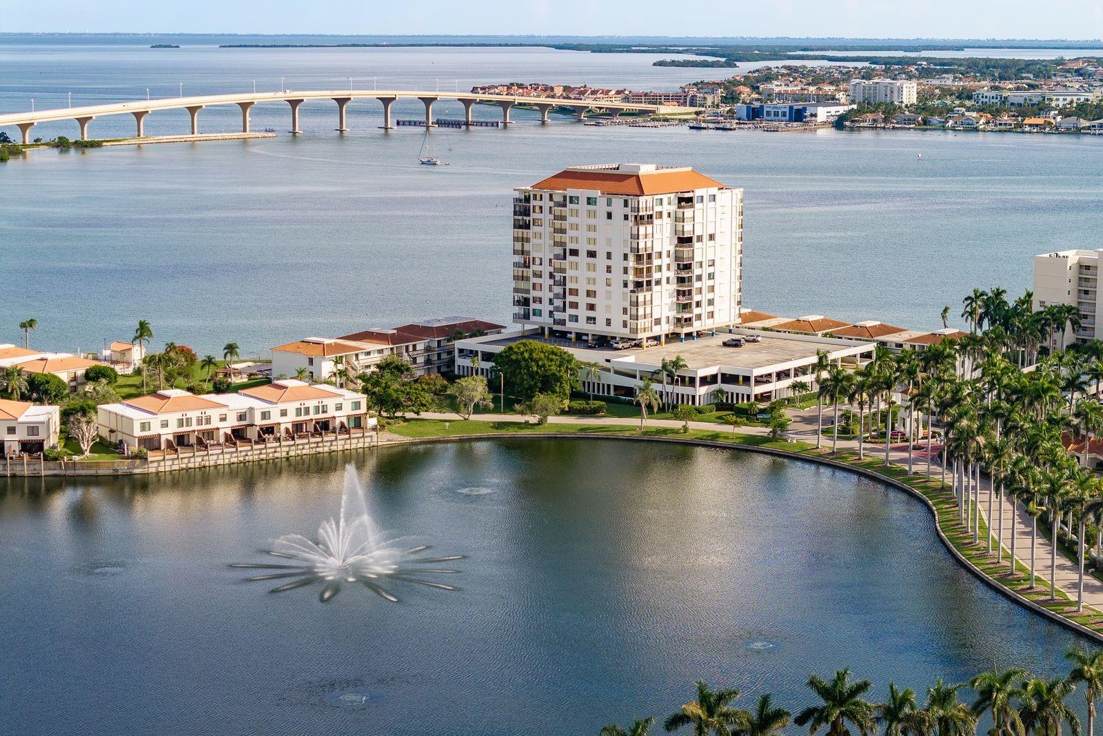 Perched on the 9th floor of Bahia Del Mar, this original-owner 2 bedroom, 2 bath condo with 1,240 sq ft offers sweeping views of the Intracoastal Waterway, lake, and community grounds from every room. The kitchen features granite countertops, maple wood cabinetry, travertine tile backsplash, breakfast bar, and tile floors, while the main living areas and primary suite are finished with luxury vinyl plank flooring. The spacious primary bedroom includes a walk-in closet and balcony access, and a dedicated laundry room is equipped with newer washer and dryer units. All windows and sliding doors have automatic shades, furnishings are negotiable, and all appliances are included. The HVAC was replaced in 2016 and water heater in 2022. Enjoy resort-style amenities including a waterfront pool and spa, fitness center, fishing pier, walking paths, and a secure building with a 3rd-floor gathering room and game room for residents. HOA fees cover nearly everything except electricity, and this building has passed its Milestone inspection. For those seeking even more, residents have the option to join the Isla Del Sol Yacht & Country Club, offering golf, tennis, pickleball, a marina, and social activities. Ideally located just minutes to award-winning beaches, Fort De Soto Park, downtown St. Petersburg, and a short drive to local airports, Bahia Del Mar offers the best of Florida coastal living.
