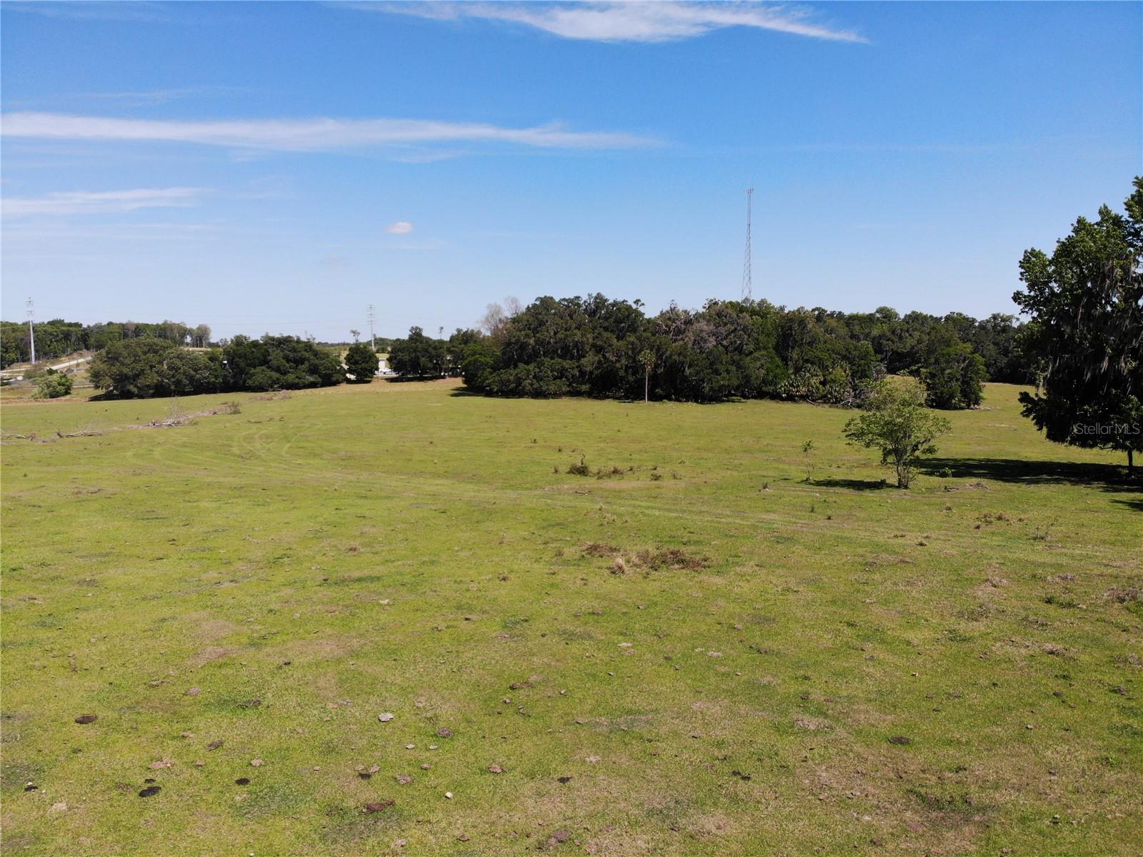 60-Acre Equestrian Property in Oxford – Prime Location with Exceptional PotentialThis 60-acre fully fenced property in Oxford offers a perfect opportunity for equestrian enthusiasts, investors, or those seeking peaceful country living. The land is cleared and ready for use, ideal for a horse ranch, equestrian estate, or farming. It also features two wells, including a 10-inch well, and a single-wide mobile home used for storage and workers.Located just 20 minutes from the Villages and shopping centers, and a short drive to the World Equestrian Center in Ocala, this property combines rural tranquility with easy access to I-75 for quick travel to Orlando, Gainesville, and beyond.With its prime location and expansive acreage, this property also holds excellent investment potential. Should zoning change, it could be developed into multiple homes or larger projects. Whether you’re pursuing your equestrian dream or investing in a growing area, this property offers endless possibilities.