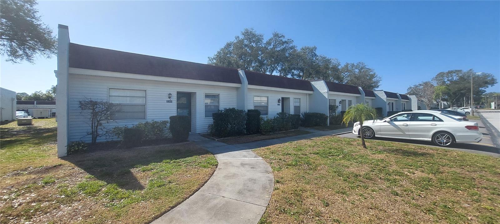 POSSIBLE LEASE with OPTION TO BUY for qualified tenant! 55+ COMMUNITY, NO PETS (except a bird or fish), 2-bedroom, 1-bath, ground floor (villa-style) END unit in Mission Oaks, conveniently located across from physician's (dermatologist) office, Publix grocery store, restaurants, hardware and Dollar store. NO FLOOD & NO EVACUATION ZONE! Brand-new A/C in June 2025, INSIDE LAUNDRY - stackable washer/dryer in window-enclosed back porch with separate LAUNDRY SINK (door to the back yard) plus inside storage room. All new laminate flooring, fresh paint in living room, new refrigerator, Walk-in Closet in large Master bedroom (to the back of unit), spacious REMODELED BATH with walk-in shower and security handles. Ready for occupancy NOW! Minimum of 6 month's rental with $3,000 security deposit (no last month collected), NON SMOKERS ONLY, one assigned open parking spot in front of the unit, plus visitor spots. Other features include: newer flat roofs, ceiling fans throughout, 2 spacious bedrooms with interior window shutters. Buyer has to get Association approved - $150 application fee. Enjoy a large, renovated Community Pool with Clubhouse and social activities. Only minutes' drive to Gulf beaches on Indian Shores, Seminole City Center, medical facilities, Movie Theater, St. Pete College, Post Office, Seminole Rec Center. Minutes to Bay Pines VA, Tyrone or Largo Mall. Background checks mandatory. Monthly rent: $1,700.- includes TV, Internet, cable, water, sewer, trash pick-up, parking spot, common areas - only pay for power and interior insurance.