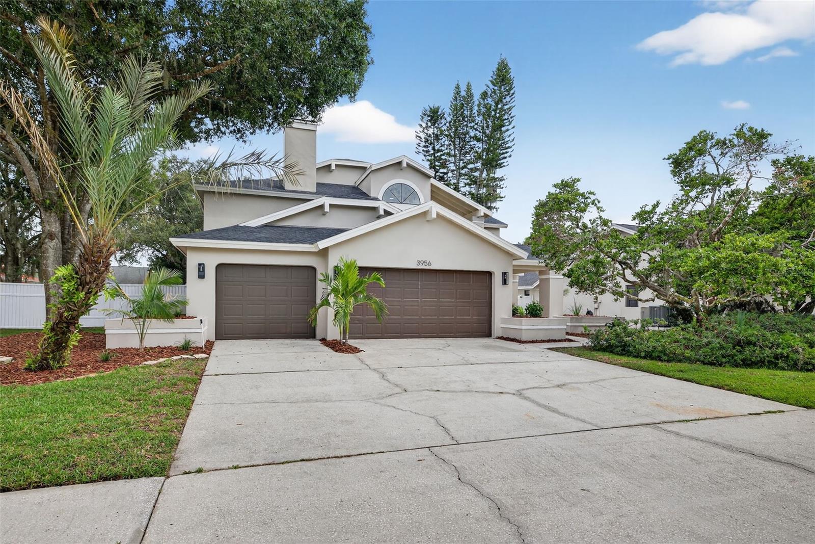 Imagine having the space to breathe--to be comfortable, spread out and truly live your best Florida life! That dream is a reality here at 3956 Belmoor Dr. in this sunny, GATED, Palm Harbor POOL HOME! This home has been meticulously designed with comfort, entertaining and style at every turn.
Located on a generous fenced lot, over a quarter acre, this 4 bedroom, 3 bath home is thoughtfully designed with Scandinavian inspired touches and modern finishes.
Stepping through the front door, you're immediately greeted by soaring two-story vaulted ceilings that let the natural light pour in. The spacious layout features engineered hardwood floors guiding you through an open and airy main level that flows easily from room to room. The formal living room is perfect for quiet evenings around the fireplace or hosting your favorites for mocktails around the bar.
The newly renovated kitchen complete with soft close cabinets quartz countertops, crisp new appliances, double ovens, wall microwave and an island ready for snacks and conversation. Whether it's holiday baking marathons or weeknight dinners, this kitchen can handle it.
Upstairs, the primary suite feels more like a private retreat. It’s oversized, with space for a sitting area or reading nook, and a walk-in closet you don’t have to compromise on. The ensuite bathroom is equally generous—an oversized soaking tub, separate shower, and dual vanities give everyone the room they need with all the luxury you're dreaming of. Imagine weekend mornings on the patio with coffee in hand, the yard stretching wide around you, and an in-ground pool just waiting to be enjoyed. It’s the kind of backyard that becomes the go-to gathering spot all summer long—grill going, music, and cooling off in your private pool complete with hot tub. The large fenced lot means there’s still space to run, garden, or let your furry friends frolic.
The three-car garage gives you plenty of room for cars, tools, bikes, and all the toys! All of this tucked inside a secure, gated neighborhood, near top schools, Honeymoon Island, Award winning beaches and hiking/biking trails. Come see for yourself what all the fuss is about--schedule your tour today!