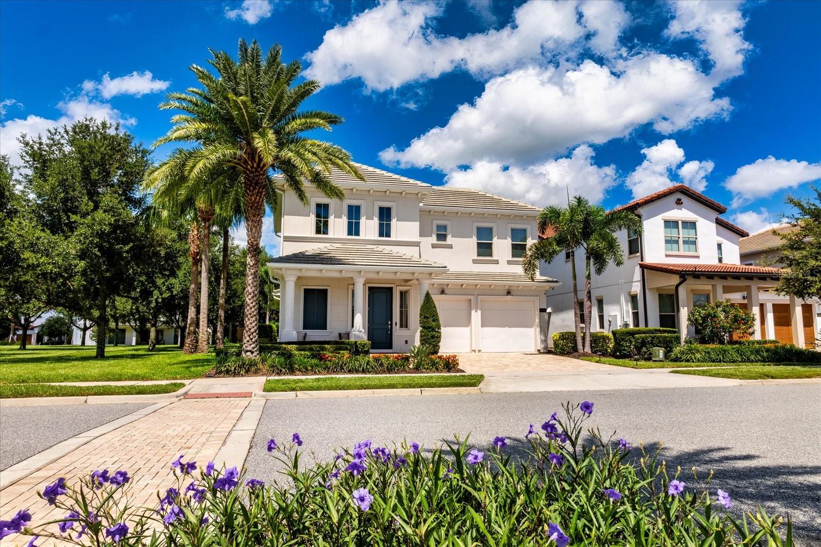 Stunning Model Home on one of the best Executive lots in Lakeshore Preserve! Discover this immaculate model home—lightly used as a second residence—nestled in one of the area’s most sought-after neighborhoods. All of the upscale furniture, decor, artwork and kitchenware is also for sale to create an easy turnkey move. Boasting every builder upgrade, this property delivers resort-style living both inside and out. You are greeted with a dramatic 2-story foyer, beautiful engineered wood flooring, accent walls with shiplap, and custom ceiling treatments throughout the living areas. The spacious, open-concept has 10' ceilings and oversized windows flooding the space with natural light. A chef's dream, this gourmet kitchen features an oversized center island, stainless steel appliances, quartz countertops, lighted custom cabinetry with glass fronts, attractive backsplash, upgraded light fixtures, and a deep farmers sink. The luxurious primary suite with a spa-inspired bathroom has dual vanities, oversized frameless glass shower, and private water closet. Off the kitchen is the laundry room and the washer and dryer are included. Take the gorgeous wood stairs to the second level to the bonus room which would be perfect for a second living area, office or play room. It also has great windows and the wood floors. Two of the secondary bedrooms share a hall bath with double sinks and a glass-enclosed tub. The 4th bedroom has an en-suite bath and walk-in closet. Moving outdoors, you have an entertaining oasis complete with an expanded, screened brick paver patio, summer kitchen, professionally-installed putting green for year-round practice right at home. A second patio has a large seating area with a cozy outdoor stone fireplace—perfect for cool evening gatherings. The views from the fenced back yard include green space behind the lot, a large community park beside the house and Lakeshore's Reflection Park across the street. Energy-efficient features include low-e windows and natural gas for cooktop, dryer and tankless water heater. All of Lakeshore has the attractive tile roofing. Lakeshore's other amenities include a beautiful clubhouse with fitness center and neighborhood activities room, resort-style pool with fountains and zero-entry shallow area, playgrounds, dog park, sand volleyball court and more. The HOA fees include all ground maintenance, 1 gig internet and cable service. Seize the opportunity to own this one-of-a-kind model home, where meticulous care and high-end upgrades create an unparalleled living experience. Schedule your private tour today!