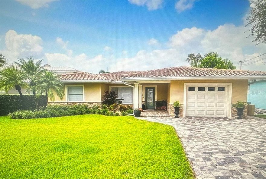 Beautiful waterfront home located on one of the premier streets in Clearwater Beach with deep water access suitable for large vessels. This bright home features an open split floor plan with stunning water views and the Clearwater Beach skyline upon entry. The primary bedroom includes a walk-in closet and private en-suite bath. The kitchen offers hardwood cabinetry, granite countertops, modern appliances, custom backsplash, built-in wine fridge, and seating for three to four. Enjoy a true waterfront lifestyle with a spacious pool patio leading to a private dock. The backyard offers green space and a fenced area near the seawall, perfect for relaxing outdoors. Custom exterior lighting highlights the home in the evening. Conveniently located walking distance to upscale restaurants, shopping, and the beautiful beaches of Clearwater. A perfect opportunity to enjoy the Florida waterfront lifestyle.