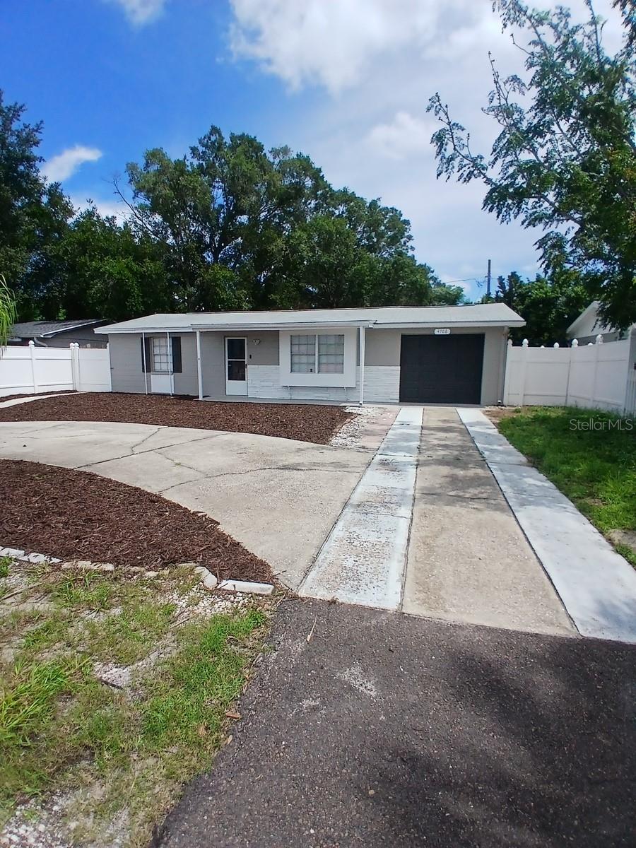 Well-kept home in Holiday with fast access to US19. Shopping and beaches close by. No flood insurance required. Roof new in 2020. Water heater new in 2020. Circular driveway and ample parking. New vinyl floors in rooms. Home exterior painted in 2024. Fenced backyard with aluminum storage shed. Screened in porch on back of house. New paint on porch and garage floors.