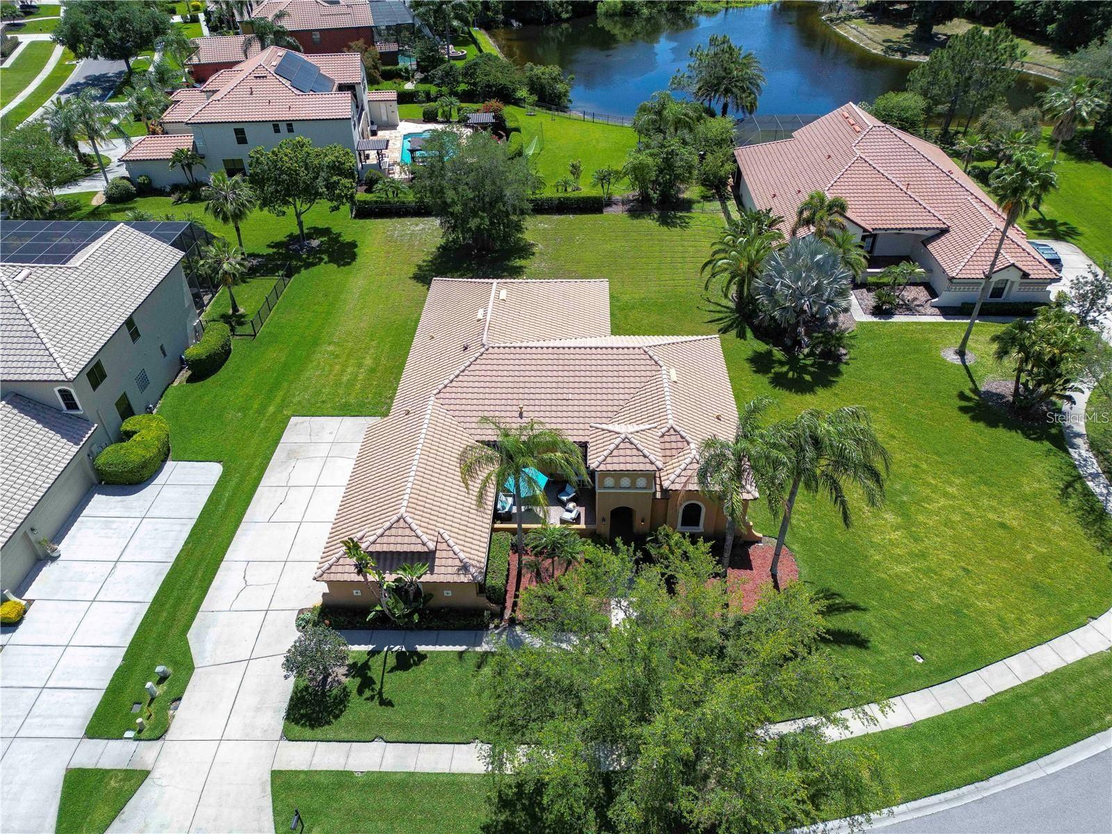 Step into this exquisite Mediterranean-style executive residence, nestled within the prestigious confines of Ballastone, an Oakstead gated community. Situated on an expansive cul-de-sac lot spanning nearly half an acre, this home presents a 3-car side entry garage complemented by an oversized driveway and parking pad. As you approach, graceful palm trees sway gently, framing a meticulously maintained emerald-green lawn. Adding to the grandeur of the exterior is an open brick-paved private patio—a serene spot to enjoy your morning coffee. Passing through archways beneath a barrel tile roof, you're greeted by an inviting entry adorned with a decorative glass front door, accompanied by a side window, and an arched transom window above. NEW A/C March 30, 2022! NEWER Water Heater January 30, 2018! NEW Dishwasher 2025! NEW Carpet in 2 Guest Bedrooms! Inside, architectural features include elegant archways, art niches, rounded corner bead walls, 8-foot doors, and an open-concept floor plan encompassing 2,573 sq ft. To the right of the tiled foyer with a floor medallion, a versatile office/study awaits. The dining room sits to the left of the foyer, while the living room lies straight ahead, boasting triple sliding doors opening onto the lanai. The heart of the home is the gourmet kitchen—a haven for culinary enthusiasts. It showcases richly appointed 42-inch wood raised panel cabinets topped with rope trim and crown molding, Corian counters, tile backsplash, and a center island Quartz topped and has ample cabinet and drawer space. Stainless steel appliances include a smooth cooktop and oven, double-door refrigerator, dishwasher, and microwave, complemented by a counter-height breakfast bar for casual dining. Adjacent to the kitchen, the café dining area features triple windows overlooking the lanai. The family room boasts a built-in media center and triple sliding glass doors leading to the wraparound screened lanai and expansive backyard. The owner's retreat beckons with an inviting alcove entrance, sliding glass doors opening onto the lanai, and double closets leading to the ensuite bath. The bath comprises a double vanity, tiled shower with coordinating Listello pattern, a deep soaking jetted tub, a walk-in closet, and a private water closet. Additional generously sized bedrooms are arranged in a 3-way split, offering ample closet space. Oakstead provides outstanding amenities, events, and activities for family entertainment, including a Clubhouse, fitness center, event spaces suitable for special occasions, a 165,000-gallon saltwater pool complete with a waterslide, sundeck, shaded areas, 3 tennis courts, volleyball and basketball courts, ball field, and covered playground. With easy access to major highways including the Suncoast Expressway, dining, sports, and entertainment options, The Shops at Wiregrass, and Tampa Premium Outlets, this home offers an unparalleled lifestyle. Don’t miss out—schedule your appointment today! Bedroom Closet Type: Built In Closet (Primary Bedroom).