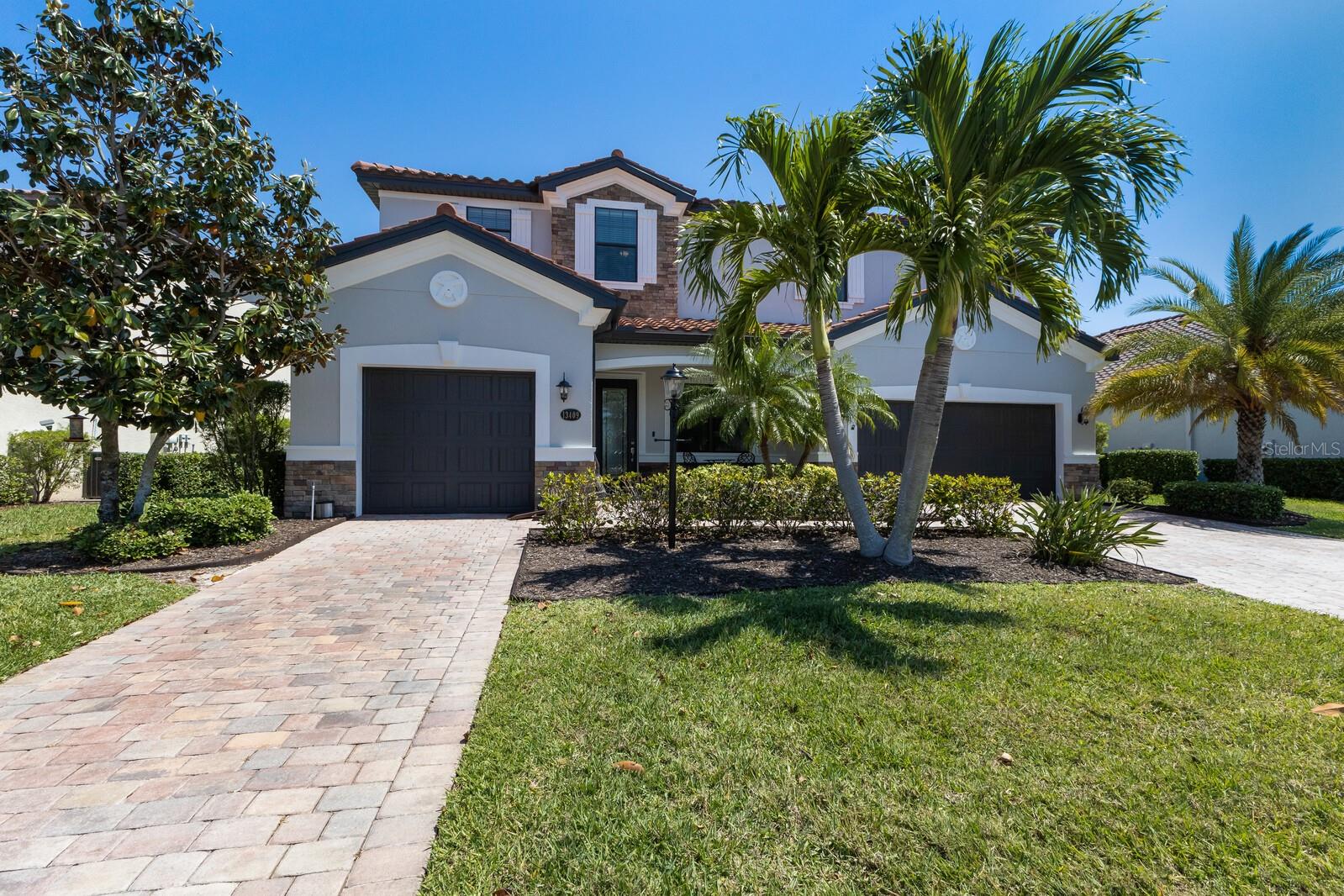 Welcome to the highly sought-after, gated community of Bridgewater, where luxury meets lifestyle.
This beautifully updated Cornell floor plan by Lennar offers 5 bedrooms, 4.5 bathrooms, a spacious loft, and a split 3-car garage—all thoughtfully designed with both entertaining and everyday living in mind.
Positioned on one of the best lots in the community, enjoy breathtaking water views from your covered, screened-in lanai, complete with brick pavers, a resort-style pool, and relaxing spa—the perfect setting to unwind or entertain as you watch Florida’s iconic sunsets.
Inside, the home features soaring 20-ft ceilings in the great room, Brazilian hardwood floors on the staircase and banister, and a light, airy open floor plan.
The recently remodeled gourmet kitchen showcases an upgraded natural gas range hood, extended countertops, custom coffee and wine bar, and a massive walk-in pantry—designed with the home chef in mind.
A secondary bedroom on the main floor makes an ideal guest suite or multigenerational living space.
Upstairs, the loft has been enclosed with a soundproof wall and solid door, perfect for a media room or home office.
The second floor also hosts four generously sized bedrooms, including a luxurious owner’s suite with a modern glass-enclosed shower.
Fresh exterior paint and lush landscaping elevate the curb appeal, while the maintenance-free lifestyle lets you enjoy all the community has to offer.
Located in the heart of Lakewood Ranch, Bridgewater is a premier neighborhood featuring only estate and manor homes with Mediterranean-style tiled roofs and mature landscaping throughout.
Enjoy proximity to top-rated schools (including a charter school within close distance), world-renowned beaches, upscale shopping, dining, and scenic trails.
A true Florida paradise, this is a rare opportunity to own a slice of luxury in one of Florida’s most desirable communities.