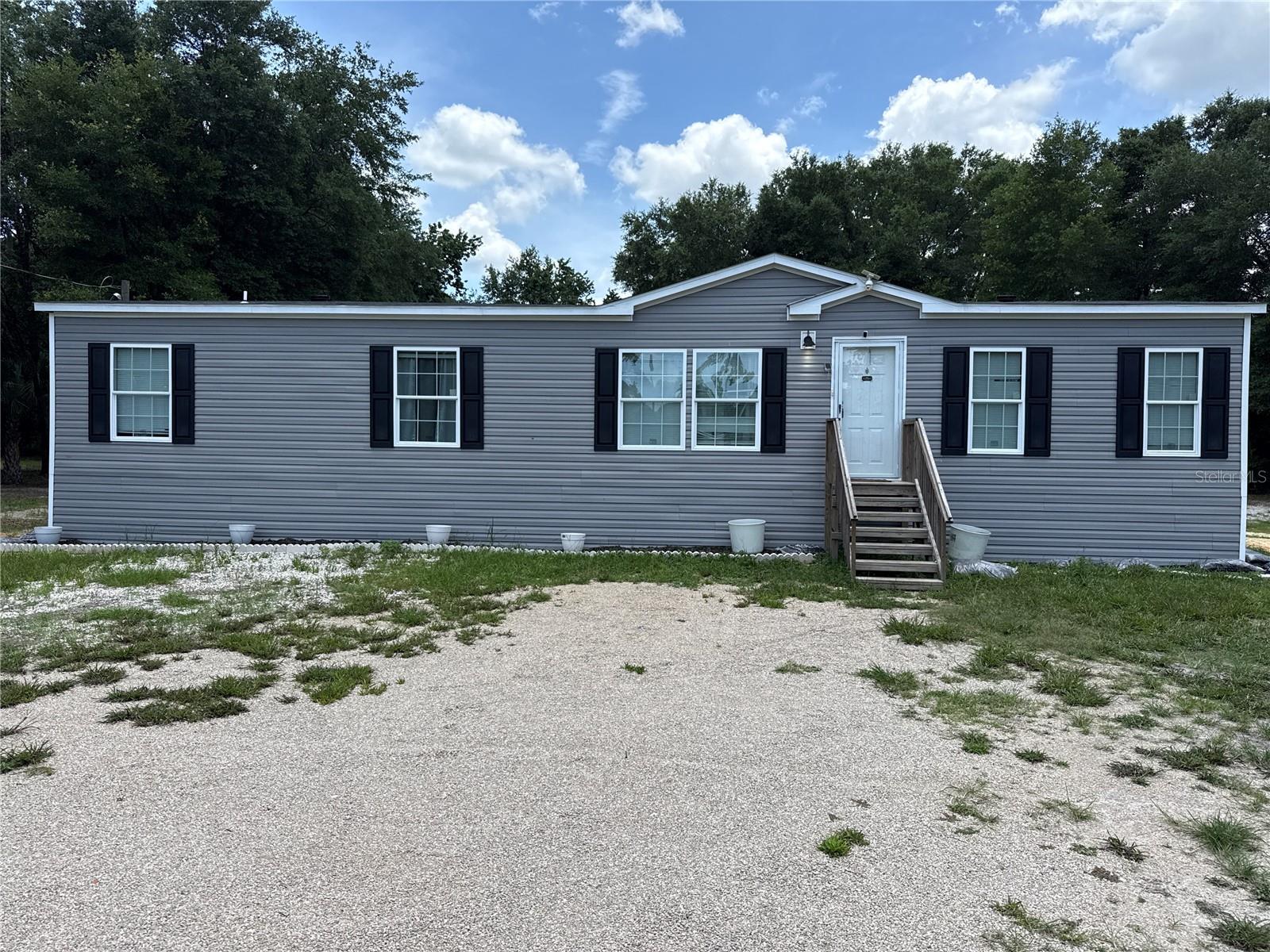 This spacious home is perfect for the nature lover and offers additional living space for guests. It is only minutes from Manatee Springs, Fanning Springs, Suwannee River and the quaint Gulf front town of Cedar Key. It sits on a dead end paved road. If you are a nature lover you’re in luck, you can sit on your porch and watch the deer, rabbits and birds enjoying this beautiful property. The main 3/2 home sits on 1.03 acres. It comes with all appliances including a full sized washer and dryer. There is a huge deck in the rear that connects to a 640 sq ft shed converted to a 1 bed 1 bath cabin. It has 100amp electric, running water, full sized refrigerator, apartment sized dishwasher, stackable washer and dyer, two window ac units (one has heat as well), and a tankless Reem water heater. There is also an above ground pool with upgraded steps, pump and skimmer.