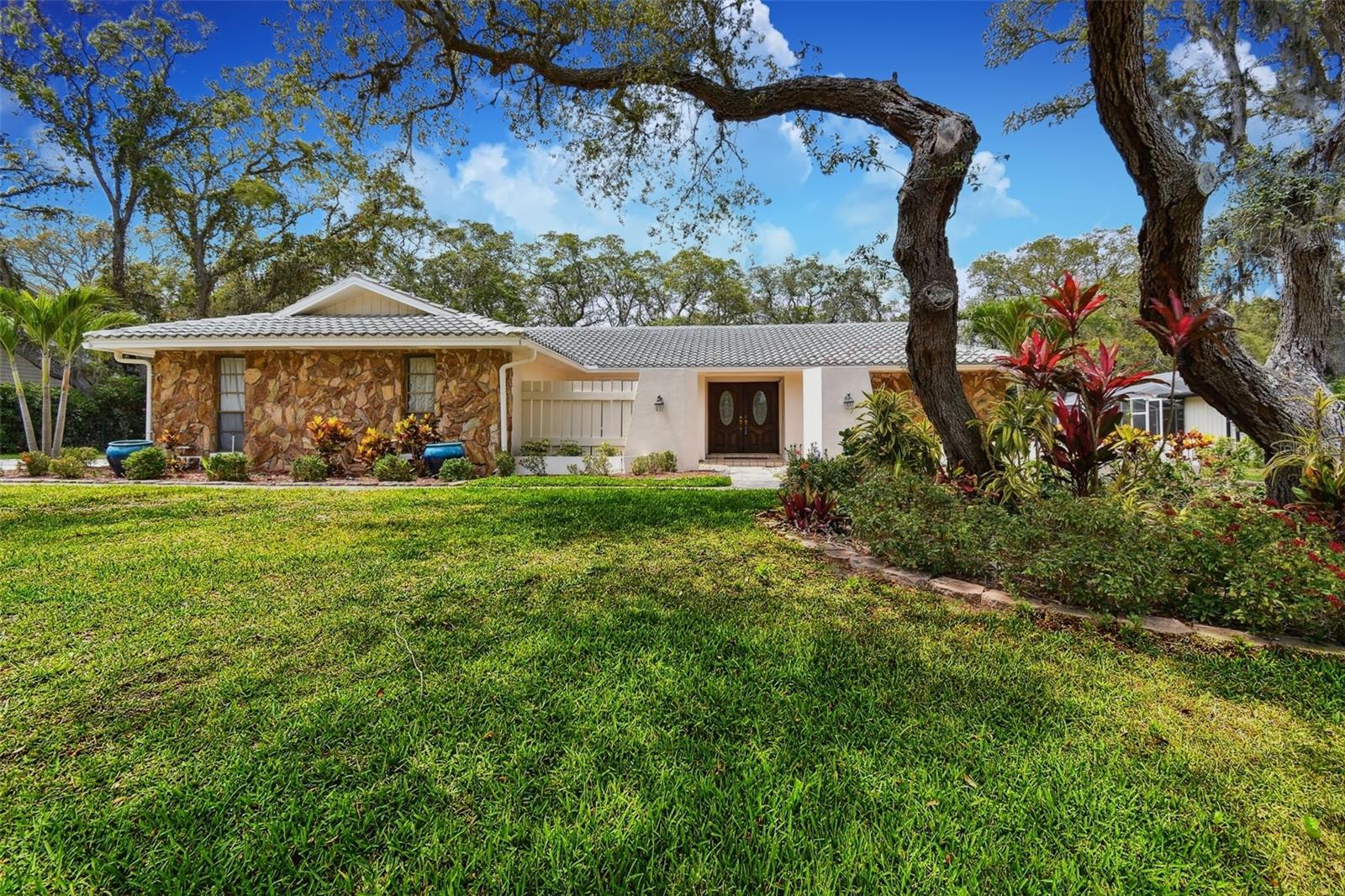 Welcome to 2840 Pheasant Run – a STUNNING POOL HOME nestled on JUST UNDER HALF AN ACRE in the highly sought-after community of Northwood Estates in Clearwater! NO FLOOD ZONE AND AN OPTIONAL HOA!!
From the moment you arrive, you'll be captivated by the home’s UNIQUE ROCK EXTERIOR, TILE ROOF, SIDE-ENTRY 2-CAR GARAGE, and LUSH LANDSCAPING. Step inside through ELEGANT DOUBLE WOODEN DOORS WITH GLASS INSERTS and enjoy over 2,500 SQ FT OF HEATED LIVING SPACE, featuring 4 BEDROOMS and 3 FULLY REMODELED BATHROOMS.
This home has been WELL MAINTAINED AND HAS UPDATES throughout and includes HURRICANE-RATED WINDOWS AND SLIDERS and LUXURY VINYL PLANK WATERPROOF FLOORING throughout most of the home. The REMODELED KITCHEN is located in the heart of the home and is a chef’s dream—complete with ALL-WOOD CABINETS, CROWN MOLDING, STAINLESS STEEL APPLIANCES, BUILT-IN MICROWAVE & OVEN, DROP-IN RANGE, STAINLESS RANGE HOOD, TRAVERTINE BACKSPLASH, and GRANITE COUNTERTOPS. A LARGE CENTER ISLAND with additional seating and pendant lighting opens into a SPACIOUS FAMILY ROOM with WOOD-BEAMED CEILINGS and a GORGEOUS STONE WOOD-BURNING FIREPLACE.
Natural light fills the home through MULTIPLE SLIDERS, including from the MASTER SUITE, LIVING ROOM, DINETTE AREA, and FAMILY ROOM—creating seamless indoor-outdoor flow to the EXPANSIVE COVERED BACK LANAI finished in TRAVERTINE TILE with CEILING FANS for year-round comfort. Step outside to your SCREENED-IN, CAGED POOL AREA surrounded by MATURE TREES and a SPRAWLING BACKYARD, perfect for entertaining or relaxing in private. This home truly shines with its NEARLY HALF-ACRE LOT, offering space and privacy rarely found in such a central location.
The LUXURIOUS MASTER BEDROOM offers a WALK-IN CLOSET, WOOD-LOOK FLOORING, and a en-suite bath featuring SEPARATE HIS & HERS VANITIES and a LARGE TILED GARDEN TUB. On the opposite side of the home, you'll find THREE GENEROUS GUEST BEDROOMS, each with SPACIOUS CLOSETS. The GUEST BATH boasts a DOUBLE VANITY WITH QUARTZ COUNTERTOPS and a TILED TUB/SHOWER COMBO, while the REMODELED POOL BATH includes a FRAMELESS GLASS SHOWER, MODERN TILE WORK, and a GRANITE VANITY.
Located in NORTHWOOD ESTATES, this home offers the peace and beauty of a MATURE, TREE-LINED NEIGHBORHOOD with WIDE LOT LINES, SIDEWALKS SHADED BY OAKS, and a WALKING PATH TO LAKE CHAUTAUQUA PARK—complete with scenic trails for biking and jogging.
You’re just minutes from US-19, POPULAR SHOPPING & DINING, GULF BEACHES, and TAMPA INTERNATIONAL AIRPORT, making commuting and travel a breeze. This is Clearwater living at its finest—PRIVATE, SPACIOUS, AND CENTRALLY LOCATED.
Don’t miss your chance to own this RARE GEM in one of Clearwater’s most desirable communities!