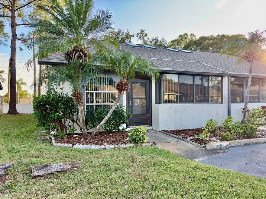 Tastefully updated villa centrally located in a private, gated community with 2 pools, pool house and picturesque ponds. With a new roof in 2024, new luxury vinyl plank flooring throughout, new lighting and fixtures, freshly painted, in unit laundry, sunroom or office space, this end unit is ready to move in! Low dues of $88 per month ($264 per quarter). Pets are welcome here.  A lovely community just minutes to area beaches, shopping, restaurants, schools, only 30 minutes to TPA, 13 mins to PIE.