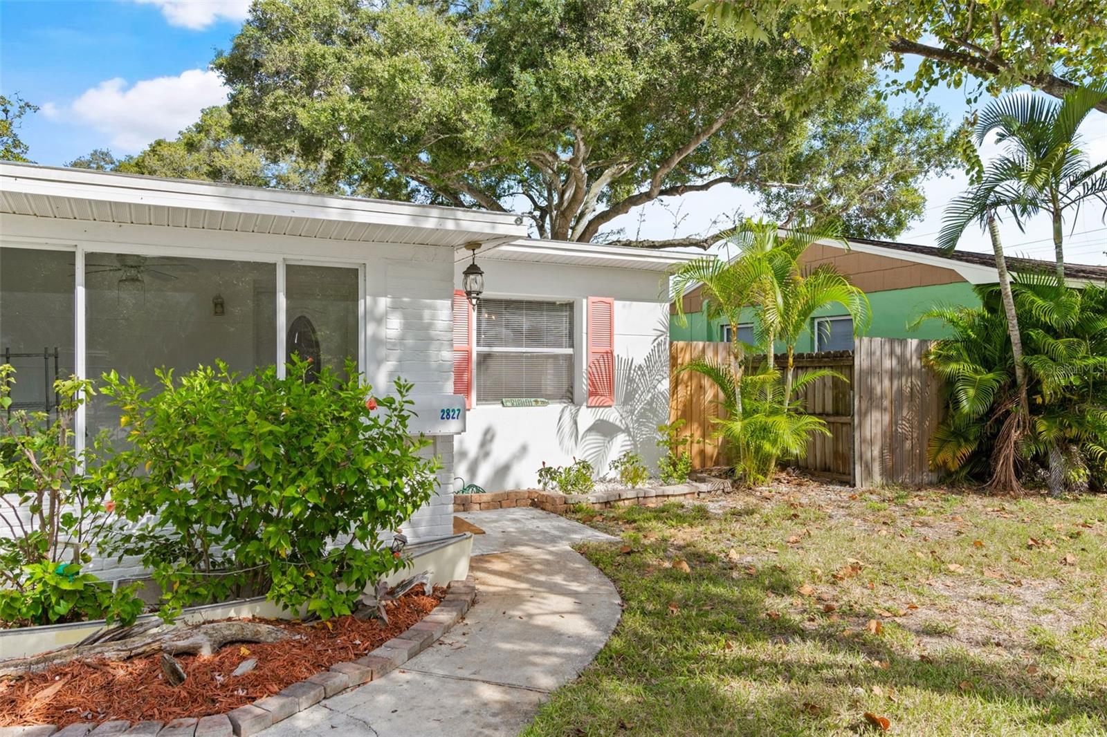 One or more photo(s) has been virtually staged. Enjoy this updated, charming 3 bedroom, 1 bathroom home including a bonus living space or rental income unit in the garage! Enter your relaxing indoor/outdoor front patio as you step into an open and spacious kitchen, dining, and living area…fitted with solid bamboo flooring and a vintage, hand cut, solid wood accent wall and ceiling. The kitchen features beautiful french doors, new bottom oak cabinets, new cherrywood butcher block sealed countertops, new plumbing hardware, and new stainless steel appliances (even equipped with a built-in air fryer!). Each bedroom offers a spacious feel with plenty of natural lighting, ceiling fans, and built-in closets. The garage is a generous 350 sqft equipped with a full bathroom, kitchenette, floor-to-ceiling cabinetry, A/C unit, ample natural lighting, along with its own beautifully-gated entryway, outdoor space, and 4 private parking spots! New fence surrounds the entire private, large backyard. The property layout allows for multiple, serene outdoor spaces to enjoy and entertain. Block house, NO flood zone, NO flood insurance, and low homeowners insurance. Roof recently updated with cool surfacing to reduce utility cost and preserve roof life! Close to all major highways, downtown St. Pete, and best of all Florida’s crystal-clear beaches.