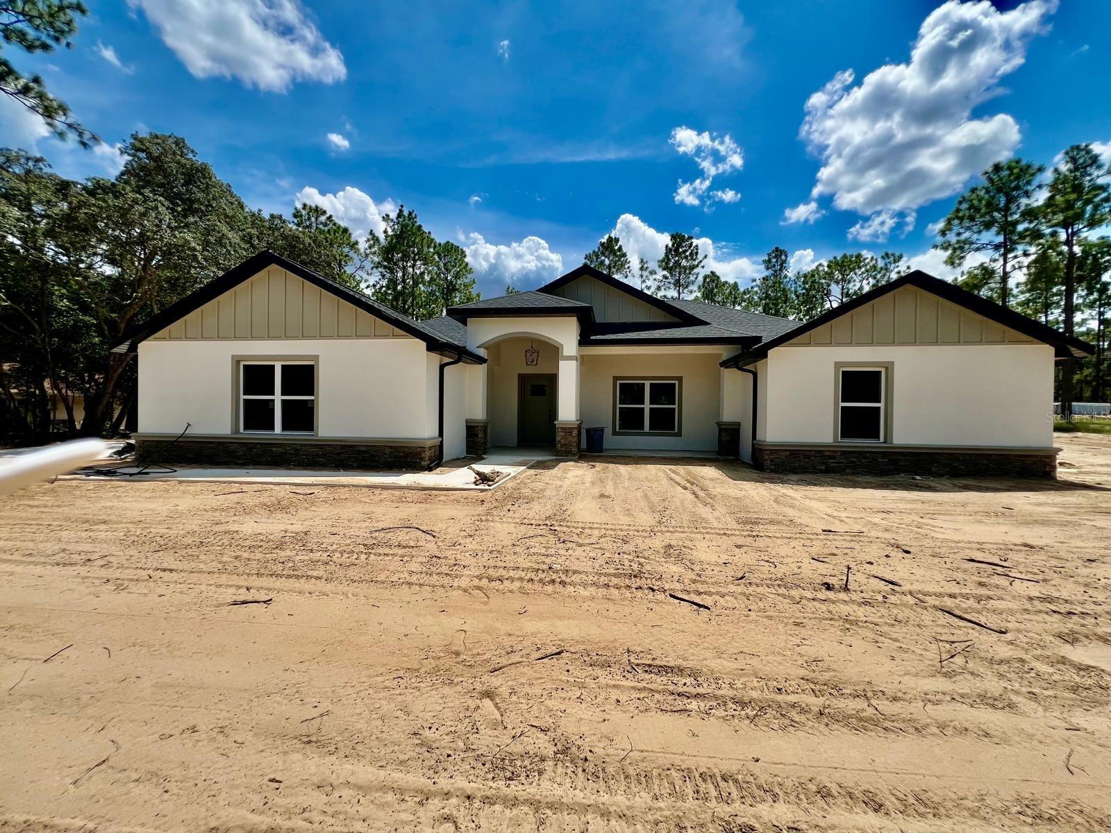 Beautiful Brad New Construction home in Ocala featuring 4 bedrooms and 3 bathrooms, a spacious 2200 sq ft heated area, and a 3083 sq ft total plan. The kitchen showcases an open-concept layout with a modern island and comes fully equipped with stainless steel appliances refrigerator, range, microwave and dishwasher. The master suite is a true retreat, featuring a GORGEOUS TILED WALK-IN SHOWER and dual vanities. Additional highlights include a covered back patio, a convenient 2-car garage and stylish modern finishes throughout. Ideally CENTERED between everything you need a few minutes from restaurants, Walmart, Publix, and more, and just minutes from OCALA WORLD EQUESTRIAN CENTER. Don't miss this opportunity—schedule your showing today!