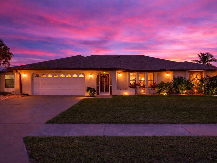 Located on a quiet cul-de-sac, this exceptional waterfront home offers direct sailboat access with no bridges and approximately 10 minutes to open water. The property has never flooded, even during recent major hurricanes, offering a rare level of confidence for waterfront buyers. Designed for true Florida living, the backyard is an entertainer’s dream featuring a heated pool with waterfall and spa, a large screened enclosure, and a 22-foot-wide covered lanai with space for an outdoor kitchen, all overlooking the canal. Boating enthusiasts will appreciate the 90-foot dock with water and electric, freshly painted and sealed in 2024, along with deep-water access ideal for larger vessels. The yard also includes a fenced dog run. Inside, the open floor plan seamlessly connects the living room, dining area, kitchen, and a second family room, creating multiple spaces for relaxing and entertaining. The kitchen features tiled countertops and overlooks the pool and water, while an interior laundry area adds convenience. The home offers three bedrooms, all with walk-in closets, and two full bathrooms, including a spacious primary suite with serene waterfront views. Major updates include a new roof in 2023 with a 15-year transferable warranty, fresh interior and exterior paint in 2023, a new irrigation pump in 2022, UV light added to the A/C system in 2023, Mr Cool Unit Installed in Garage in 2023, and a pool heater installed in 2017. Also an attached storage area beside the garage with its own AC unit. Conveniently located near shopping and dining, this home also offers quick boating access to the Caloosahatchee River and out to the Gulf of Mexico, delivering the ideal blend of comfort, location, and waterfront lifestyle.