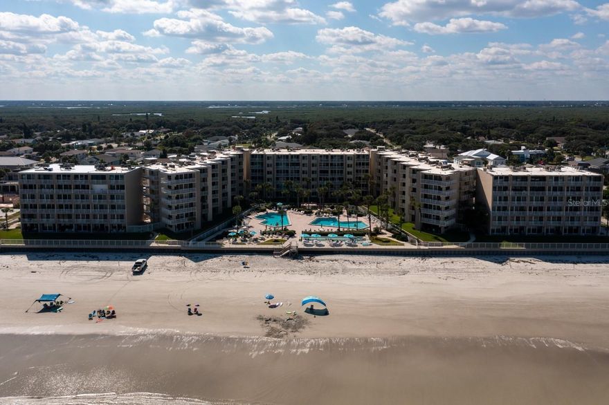 Beautiful Oceanfront condo located in the heart of New Smyrna Beach! This immaculate 2 bedroom, 2 Bathroom dream condo is fully furnished with an open concept. The floor plan features tile flooring throughout, a chef-inspired kitchen in a creamy palette with granite countertops, beautiful cabinetry w/ lots of storage and like new appliances. Two very spacious bedrooms with large closets. Just imagine relaxing on your private balcony, overlooking two incredible pools, watching the waves roll in & breathing the clean ocean air. Very well maintained & cared for, true pride of ownership exemplified throughout. FULLY TURNKEY & Ready to enjoy or rent today! Walking distance to Shopping & Dining! If oceanfront living in the coolest town in Florida is what you're looking for, than this is it! ;Water: City