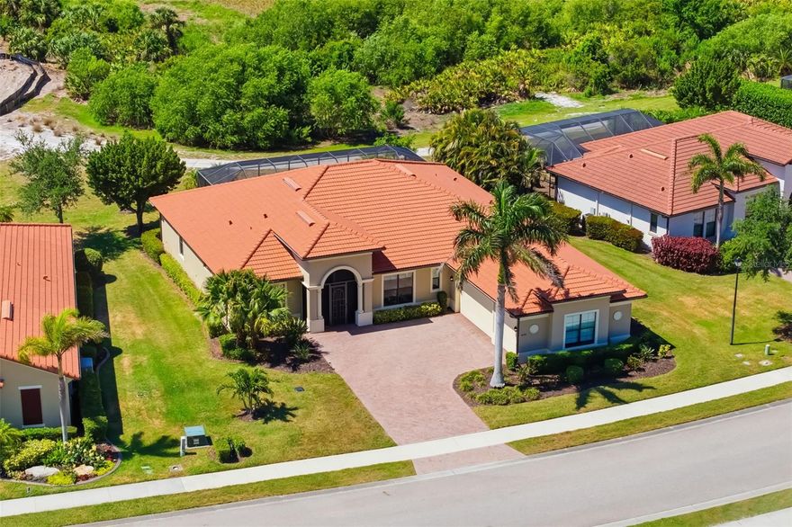 One or more photo(s) has been virtually staged. Original owner offering this exceptional Turnberry estate in the prestigious Sarasota National, built by WCI and conveying two golf memberships. Beautifully maintained and thoughtfully upgraded, this home features natural gas, full IMPACT windows and doors, 3 bedrooms, 2 flex rooms, 4 full baths, and a 3 car side load garage. Enjoy wide golf and water views from the expansive lanai, along with peace of mind from the whole house Kohler generator, new HVAC (April 2026) with transferable warranty, and MMTC Knox Box with Knockout. Designed for everyday living and effortless entertaining, this home showcases soaring ceilings, tile flooring throughout, and a spacious great room with 3 panel sliders that open to the lanai for seamless indoor–outdoor living. The chef’s kitchen impresses from layout, size, and abundant storage, and quartz countertops, soft close cabinetry with pull outs, under cabinet lighting, stainless appliances, and an oversized island. Two dining areas accommodate both casual and formal gatherings. The primary suite offers two walk in closets with organizers, spacious bath with dual sinks, and a large walk in shower. All guest bedrooms include en-suite baths and walk in closets. Two versatile flex spaces—one at the front of the home and one overlooking the lanai—are ideal for a home office, media room, fitness studio, or hobby space. Outdoor living shines with a bronze screen enclosure, heated saltwater pool with sun shelf and spa, and a brick paver deck. Additional highlights include an 80 gallon hot water heater, full glass front door, screened entry, and a well appointed laundry room with oversized LG appliances, cabinetry, and utility sink. Sarasota National offers resort style amenities including an 18 hole championship golf course (currently being renovated), on site dining, fitness center, tennis, pickleball, and a vibrant social calendar. Ideally located near Wellen Park, CoolToday Park, downtown Venice, and Gulf beaches. This outstanding home is ready for its private showing—don’t miss it.
