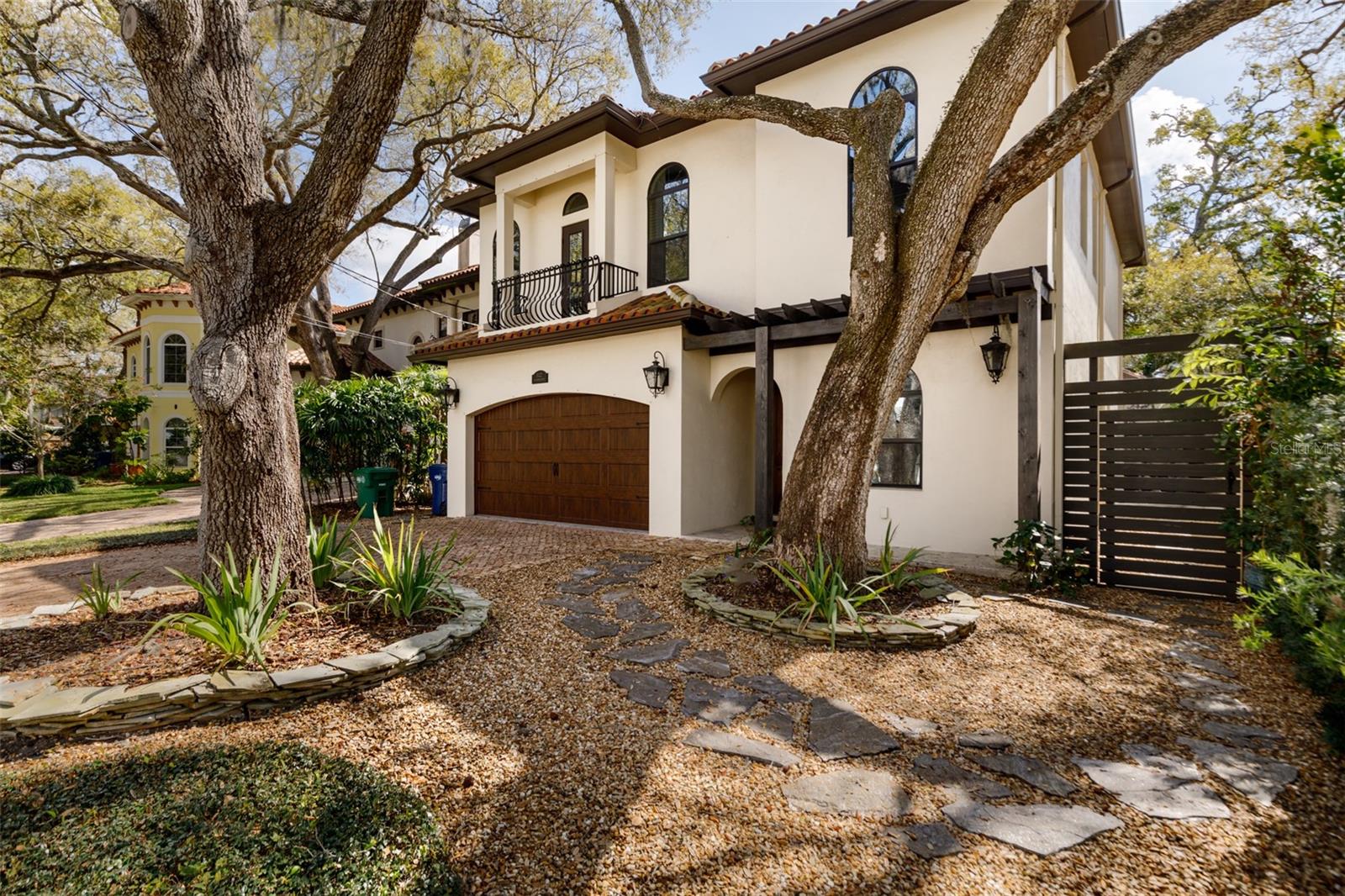 Welcome to the heart of South Tampa! This 4 bedroom + office/den home is conveniently located in the highly sought-after neighborhood of Bayshore Beautiful. On a picturesque street with design details that will draw you in as you pull up on a Chicago reclaimed brick driveway, oversized front door with gas lantern to accent the Mediterranean design and exquisite architectural features. Once you walk through the entryway, you'll notice high ceilings, recessed lighting, and elegant hanging light fixtures that add to the ambience of the home. Immediately to your right is a large den with double doors which is perfect for a playroom, office, or guestroom. As you enter the expansive family room, you'll see the open floorplan is designed to accommodate and open living / entertainment space or can be sectioned to create two living areas and allow for a smaller TV area and includes an elegantly designed half-bathroom. The large gourmet Chef's kitchen is complete with high-end stainless steel appliances including gas range, granite counters, oversized island for counter seating, 42" solid wood cabinets, walk-in pantry with custom built-in's and additional refrigerator is perfect for get-togethers with the family or friends. The laundry room offers additional storage and a utility sink. The kitchen includes access to a stunning additional Florida room complete with built-in mini-fridge, grill, and cooktop burners. The Florida room features accordion hurricane doors that open completely to allow access to the screened in lanai with travertine tile and a granite-top bar-height island. Newly added Astroturf lines the additional yard space and a custom vertical slate fenced completely surrounds the yard creating privacy and peace. As you go up the stairs detailed with wrought iron railing, the second floor opens up to four bedrooms including the oversized primary bedroom suite, 3 guest bedrooms, and a nook that can be used for additional study space. The master bedroom has hardwood flooring, oversized en suite bathroom with clawfoot soaking tub (complete with chandelier) and a separate glass shower, marble counters and tile, dual sinks, built-in vanity, and professionally designed walk-in custom closet with built-in shelving and marble counter space. The guest rooms are located across from the master suite, one of which boasts its own en suite bathroom and Juliet balcony; and the two remaining guest rooms are close to an additional guest bathroom. This luxe Mediterranean home has been meticulously maintained with top-of-the-line details and upgrades and designed with careful consideration including a tankless water heater, gas appliances, 2 HVAC systems, water softener system, hurricane windows and doors, and top-of-the-line finishes. Just blocks from Bayshore Blvd, you will enjoy this stunning South Tampa custom home. Call today to schedule your showing!