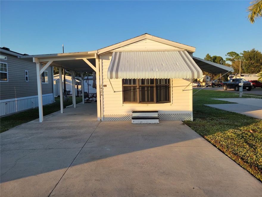 Welcome to this move in ready 1990 manufactured park model with 396' of efficient, comfortable living in the desirable 55+ community of Alligator Park in Punta Gorda. Thoughtfully maintained this fully furnished 1 bedroom, 1 bathroom residence is the best-priced home in the community—and the price includes the park share valued at $60,000!

Recent updates include a new shingle roof (2022), heavy-duty double-insulated carport with sturdy 4x4 posts, two energy-efficient mini split A/C units (2023) to help keep electric bills low. The inviting bedroom features a queen-size bed, built-in closet, with dresser drawers, while the cozy living room offers a sofa with a queen-size air mattress—perfect for overnight guests. You’ll also enjoy two smart TVs for streaming entertainment.

The updated bathroom boasts a new walk-in shower and comfort-height toilet (2023). The well-equipped kitchen features a quaint dining area, refrigerator/freezer (2022), microwave, two induction cooktops, countertop appliances, and plenty of storage. Durable laminate flooring runs throughout—no carpet—and the home has been smoke-free and pet-free!

Extras include hurricane shutters for all windows and doors, a double parking pad plus covered parking under the carport, an added bonus 8' x 10' shed with washer, dryer, sink, workshop space, and more storage.

Alligator Park offers a friendly, active 55+ lifestyle just minutes from downtown Punta Gorda, waterfront dining, shopping, and outdoor recreation.  Don’t miss this opportunity to own a well-cared-for home in one of Punta Gorda’s most sought-after communities—turn key and ready for you to enjoy!
